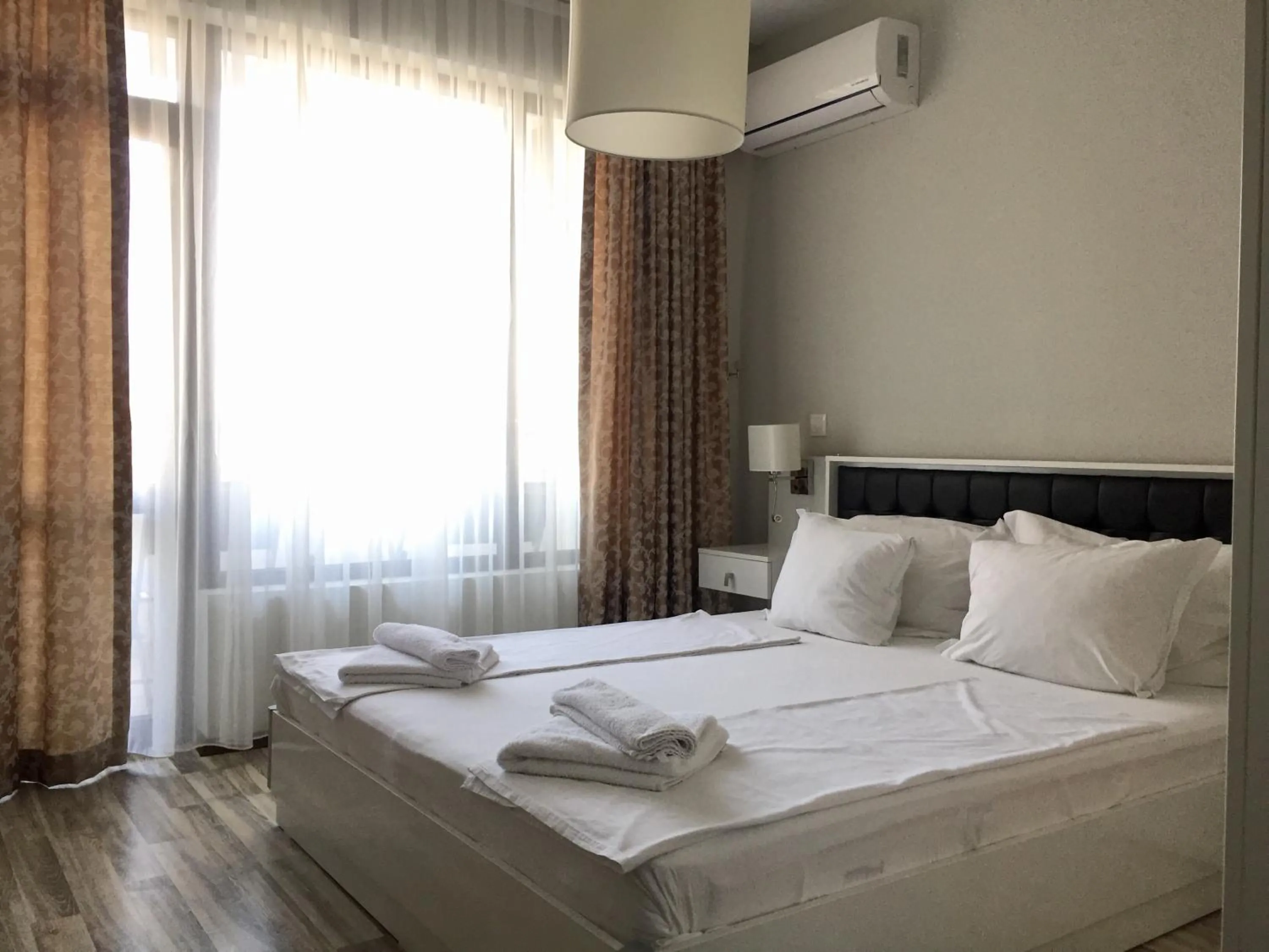Bed in Green Paradise Deluxe Apartments