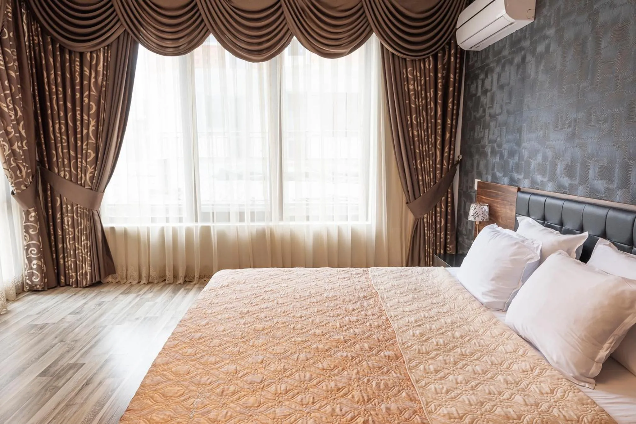 Bed in Green Paradise Deluxe Apartments
