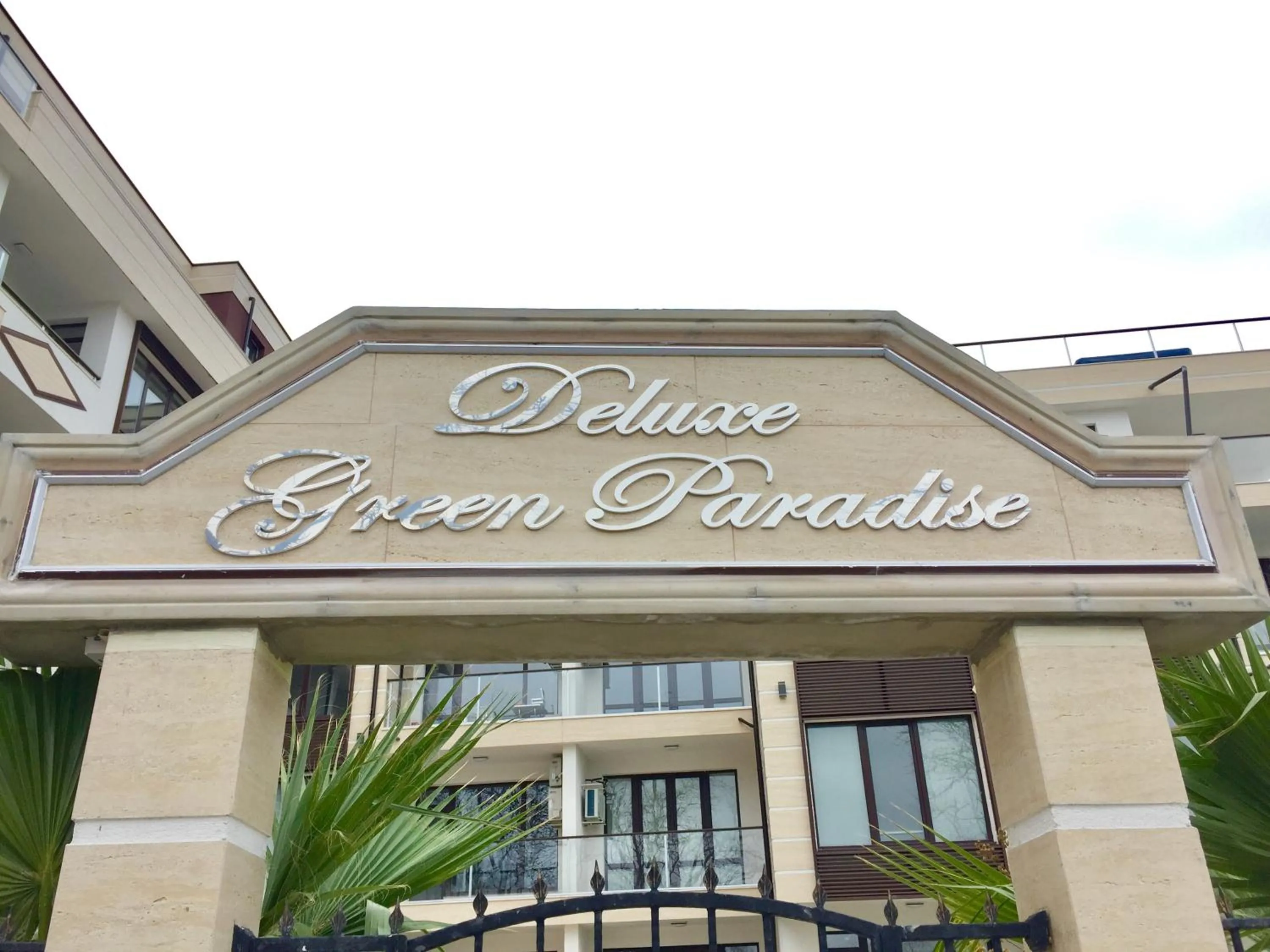 Property logo or sign in Green Paradise Deluxe Apartments