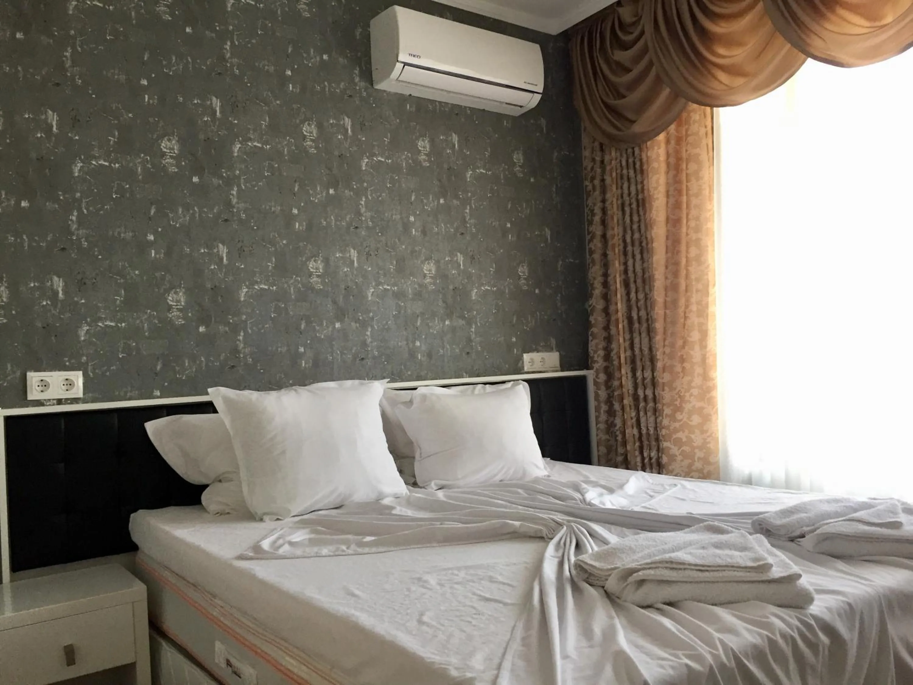 Bed in Green Paradise Deluxe Apartments