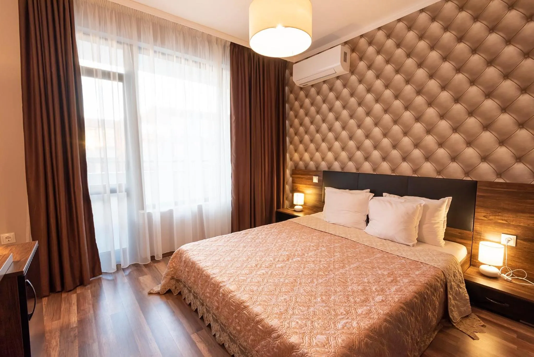 Bed in Green Paradise Deluxe Apartments