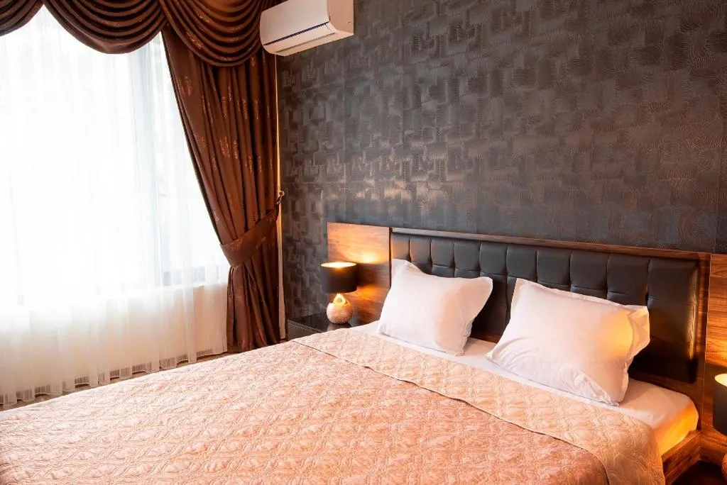 Bed in Green Paradise Deluxe Apartments