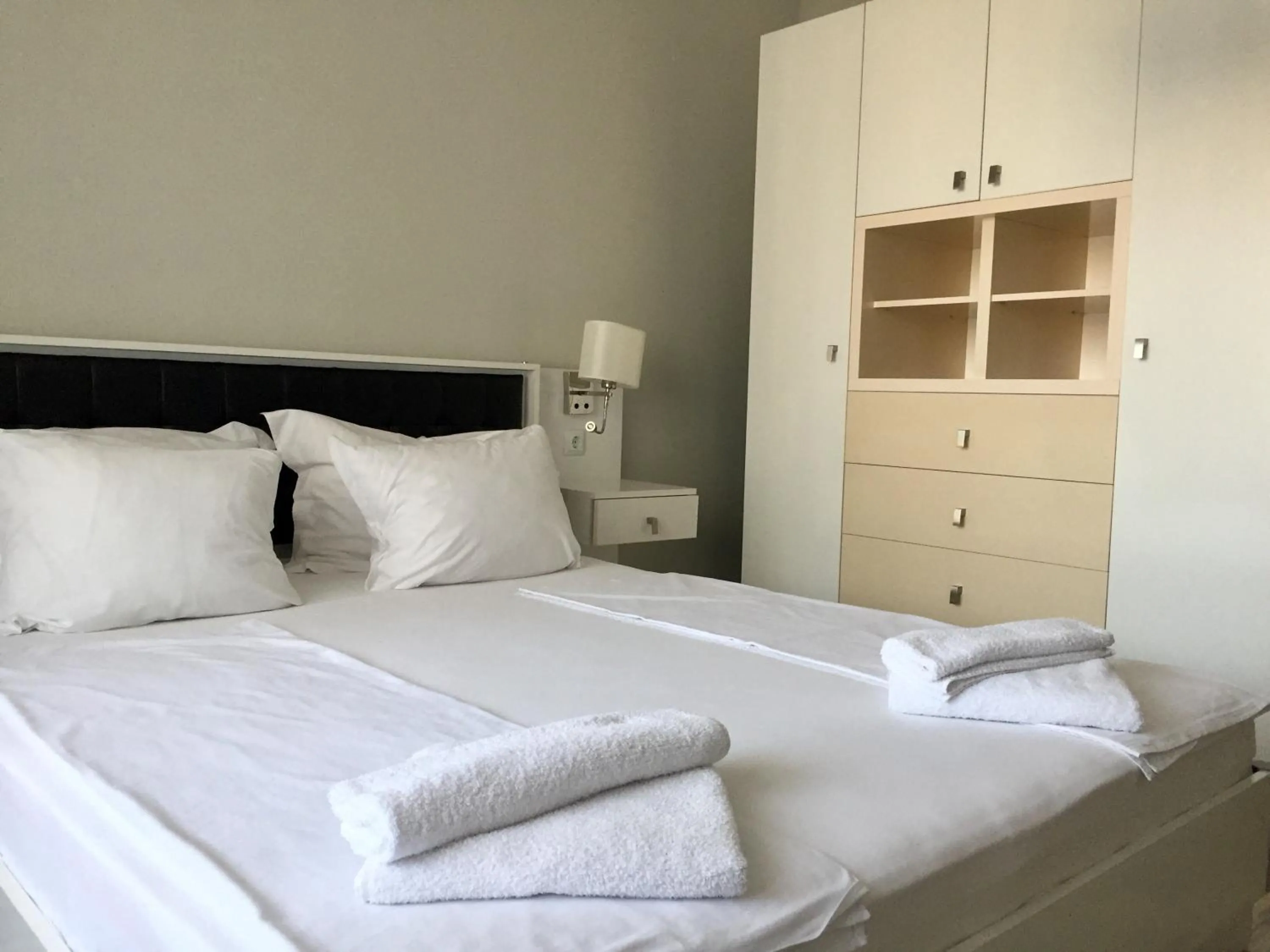 Bed in Green Paradise Deluxe Apartments