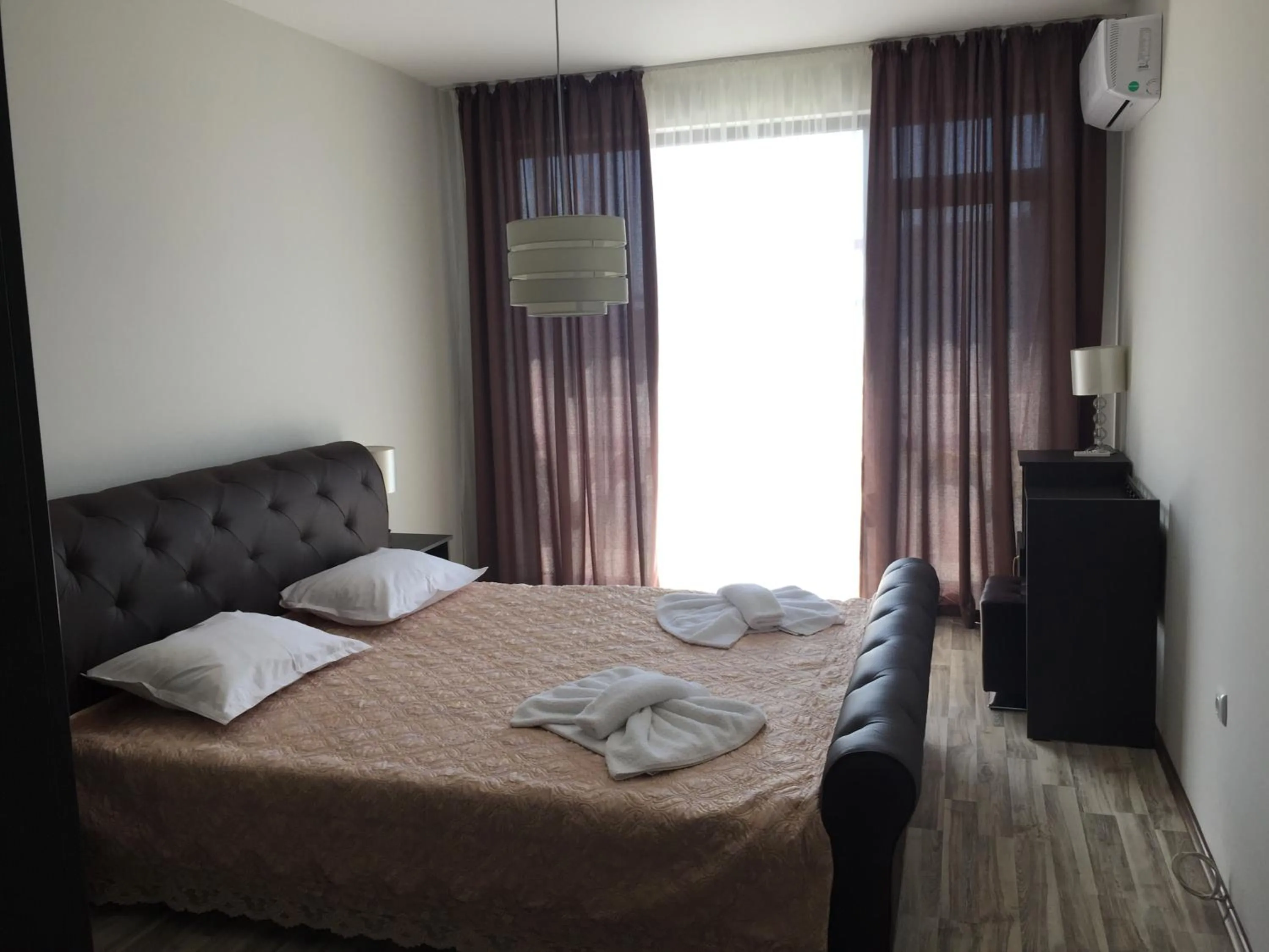 Bed in Green Paradise Deluxe Apartments