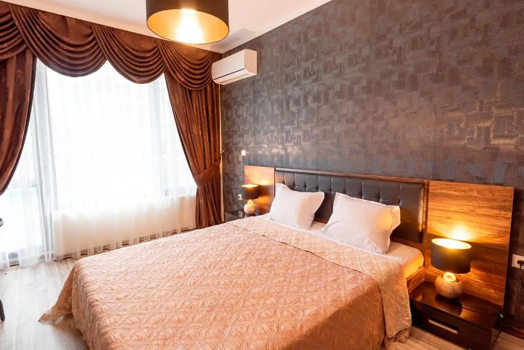 Bed in Green Paradise Deluxe Apartments