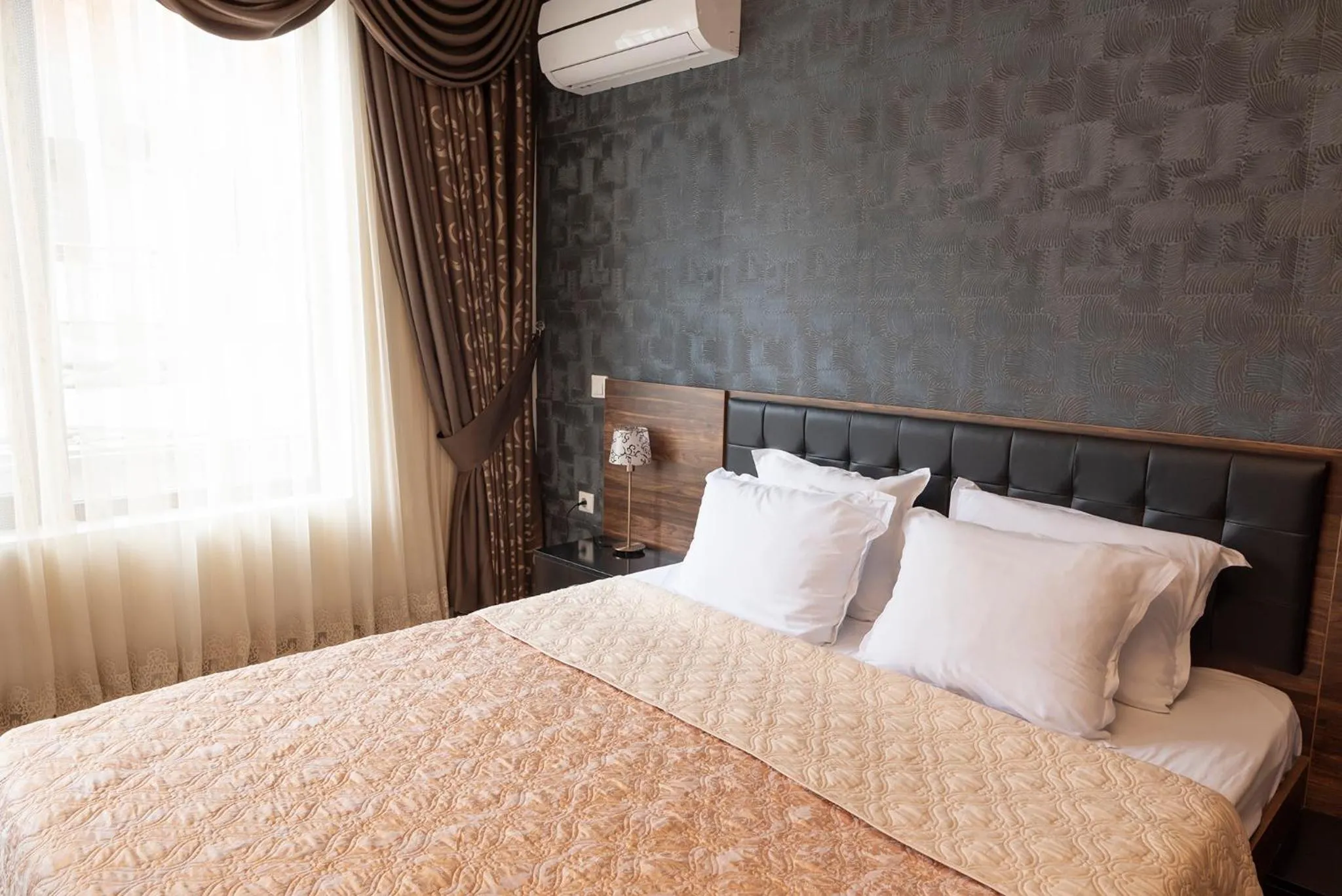 Bed in Green Paradise Deluxe Apartments