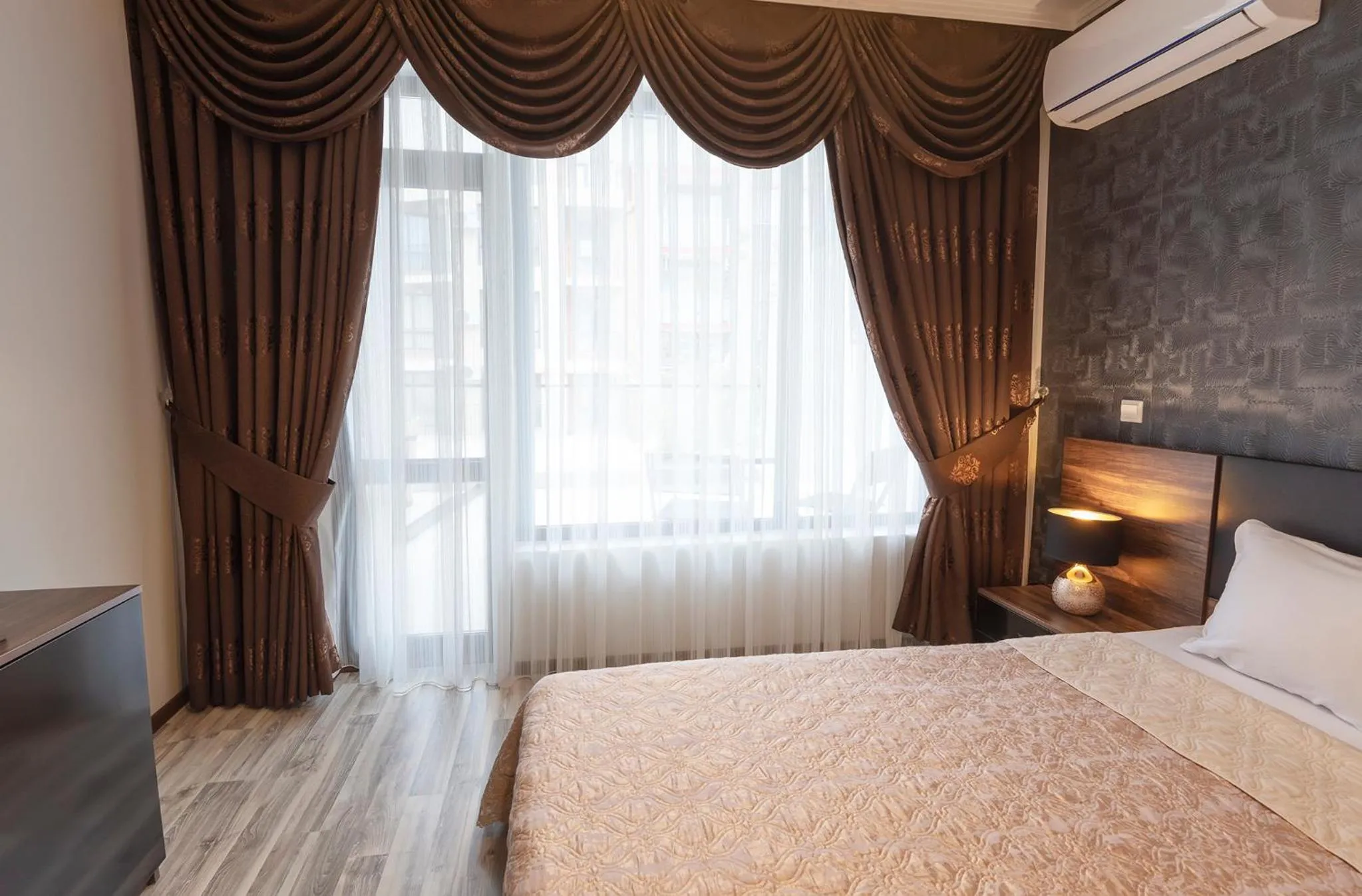 Bed in Green Paradise Deluxe Apartments