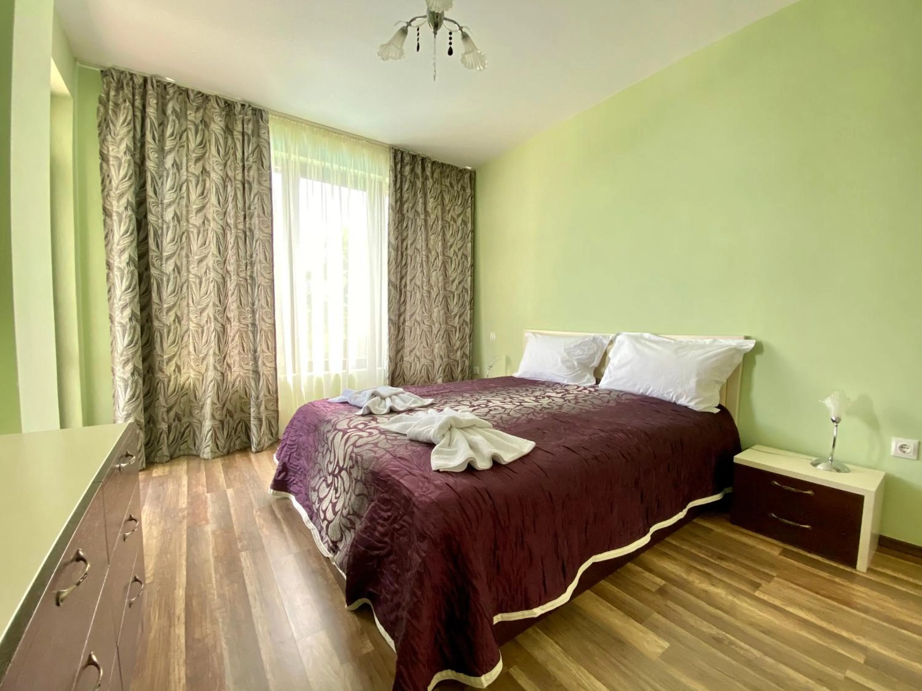 Bed in Green Paradise Deluxe Apartments