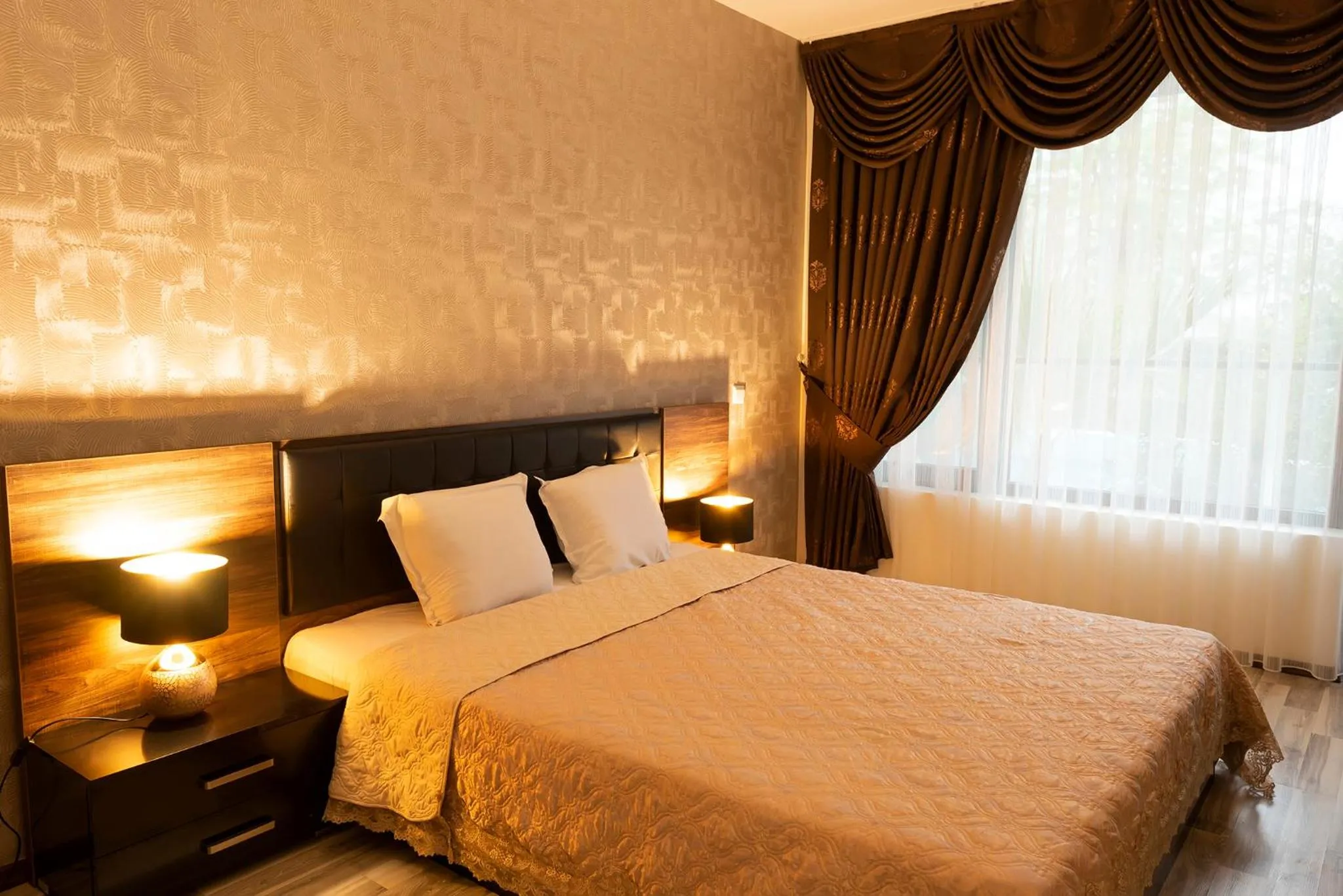 Bed in Green Paradise Deluxe Apartments