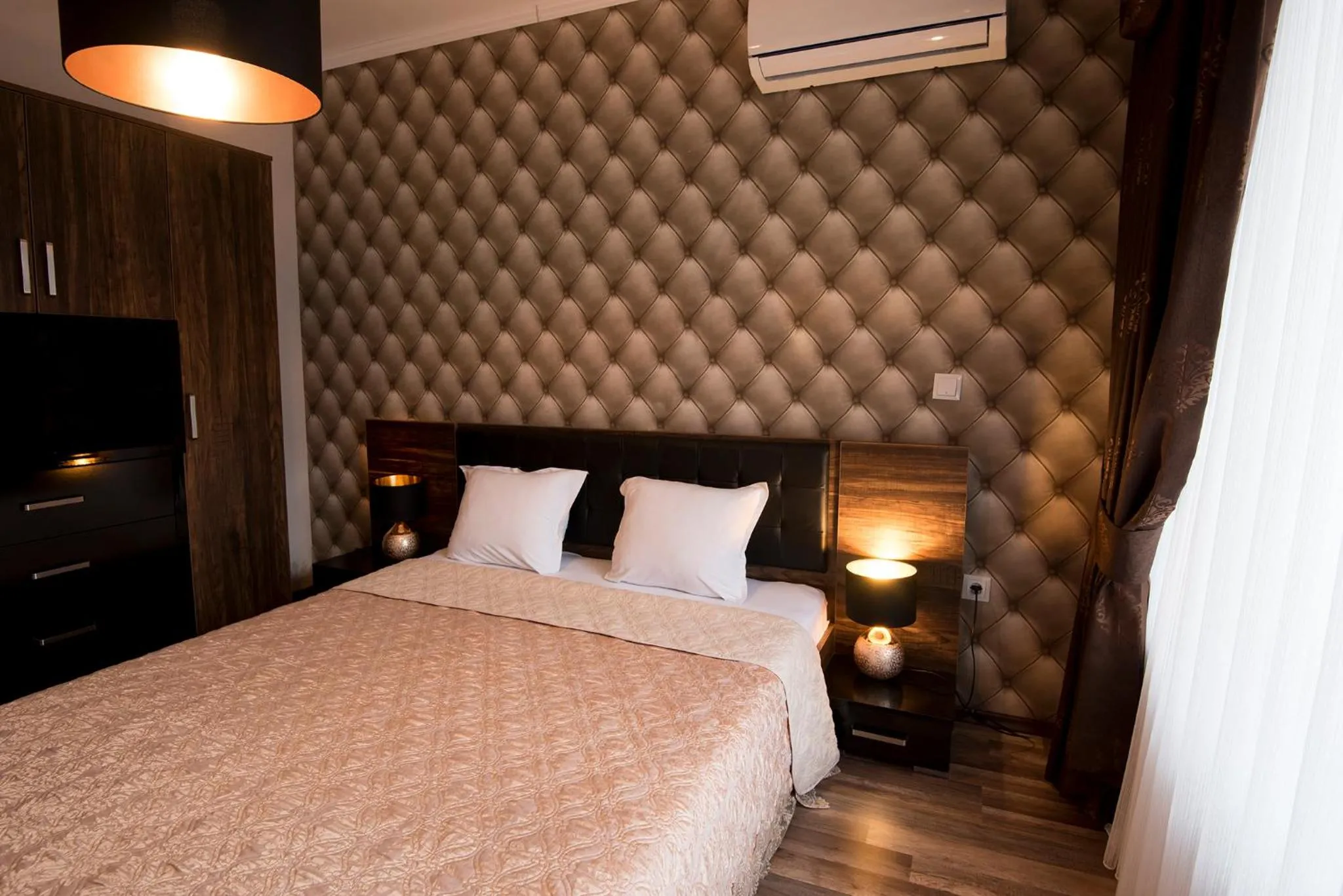 Bed in Green Paradise Deluxe Apartments