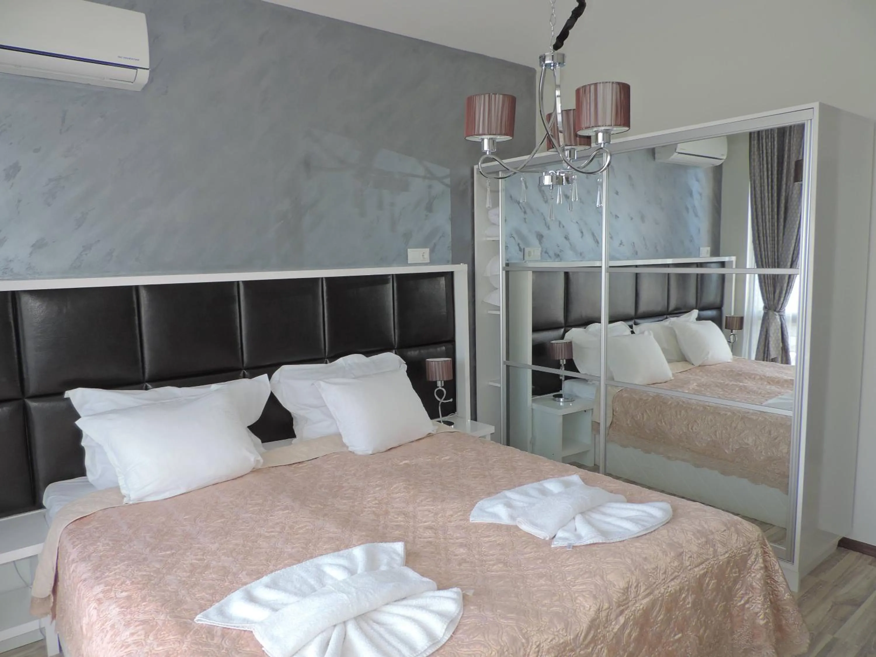 Bed in Green Paradise Deluxe Apartments