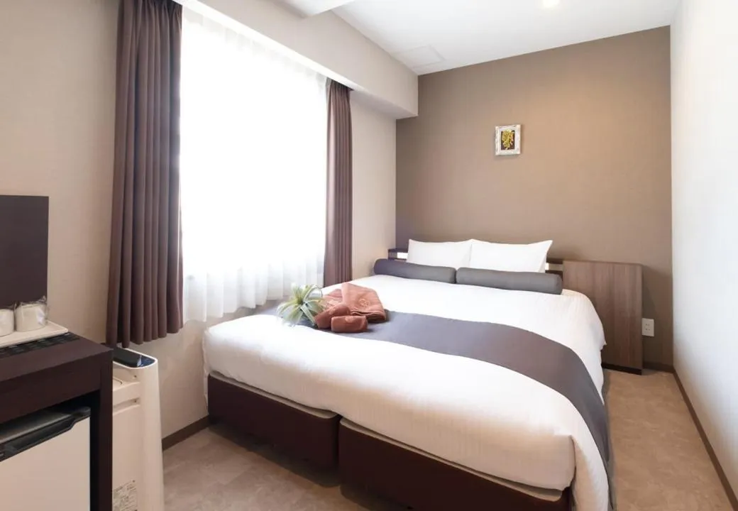 Bed in Sonezaki Luxe Hotel