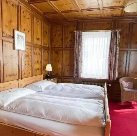 Bed in Boutique Hotel Engadinerhof - A Home for Generations