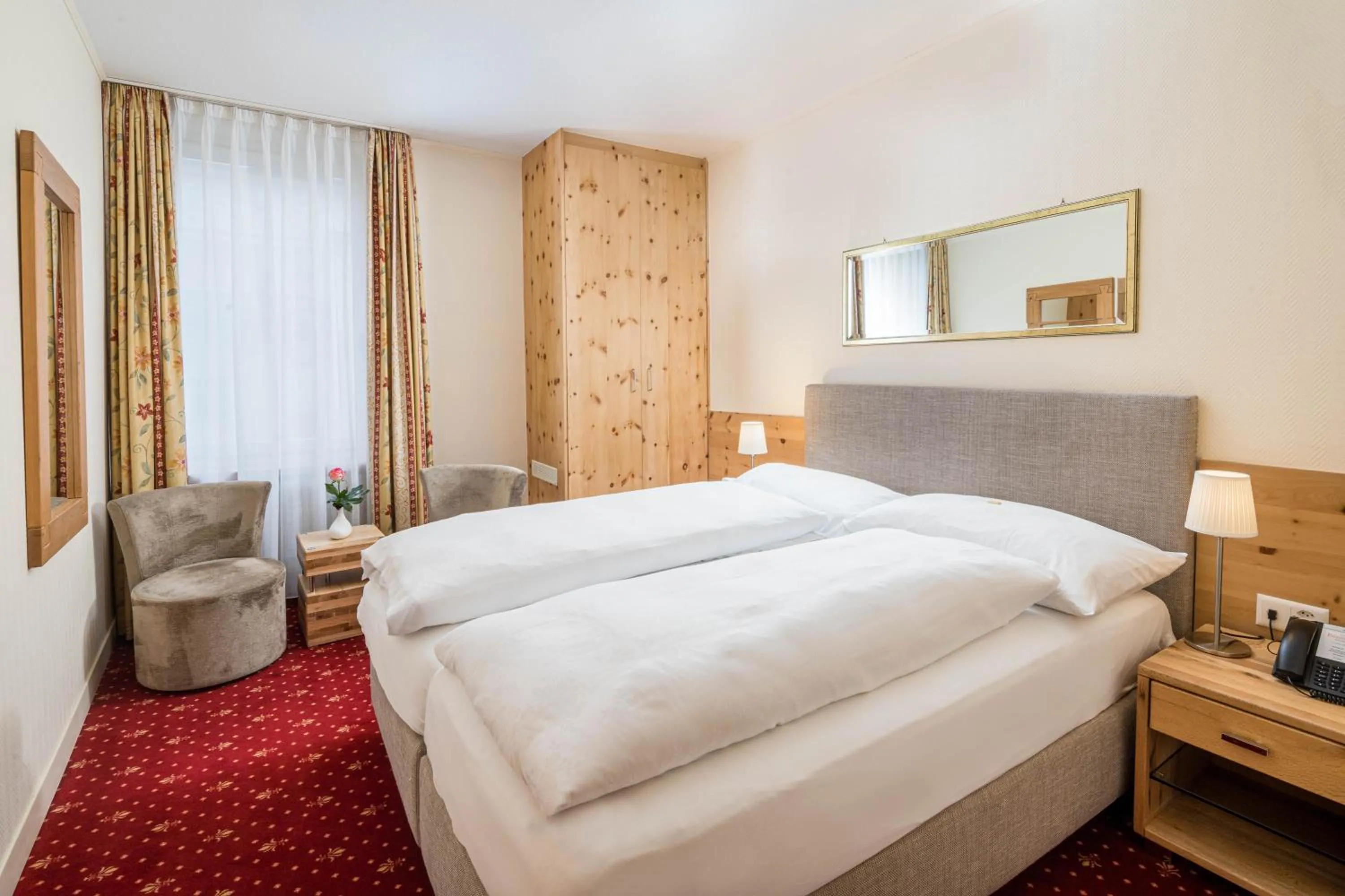 Photo of the whole room, Bed in Boutique Hotel Engadinerhof - A Home for Generations