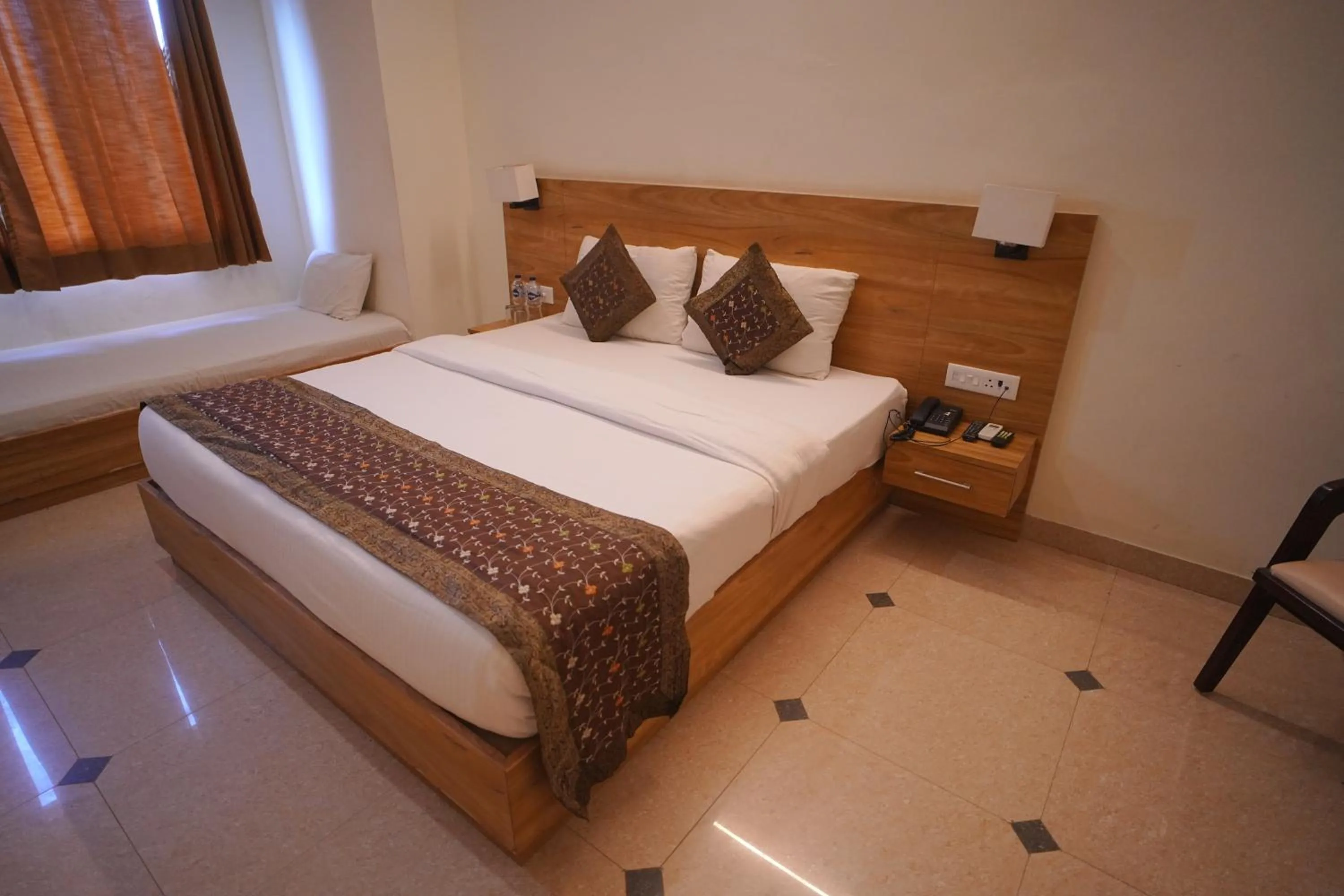 Bed in Dhawala Resort By Aamod