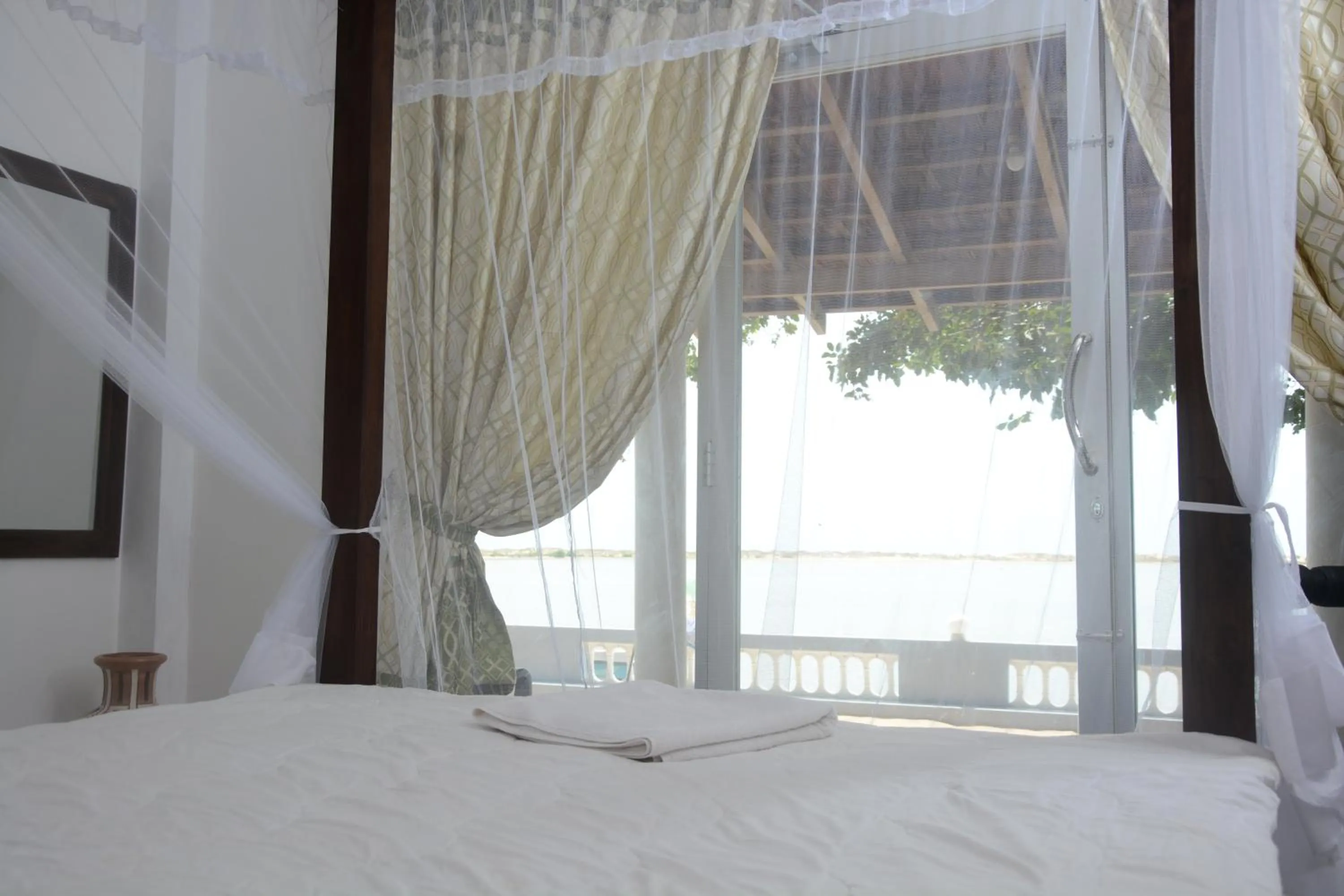 Bed in Dinuda Lagoon Hotel