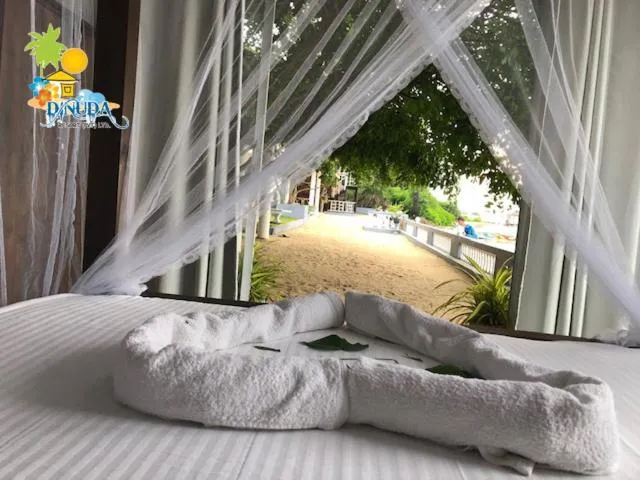 Bed in Dinuda Lagoon Hotel