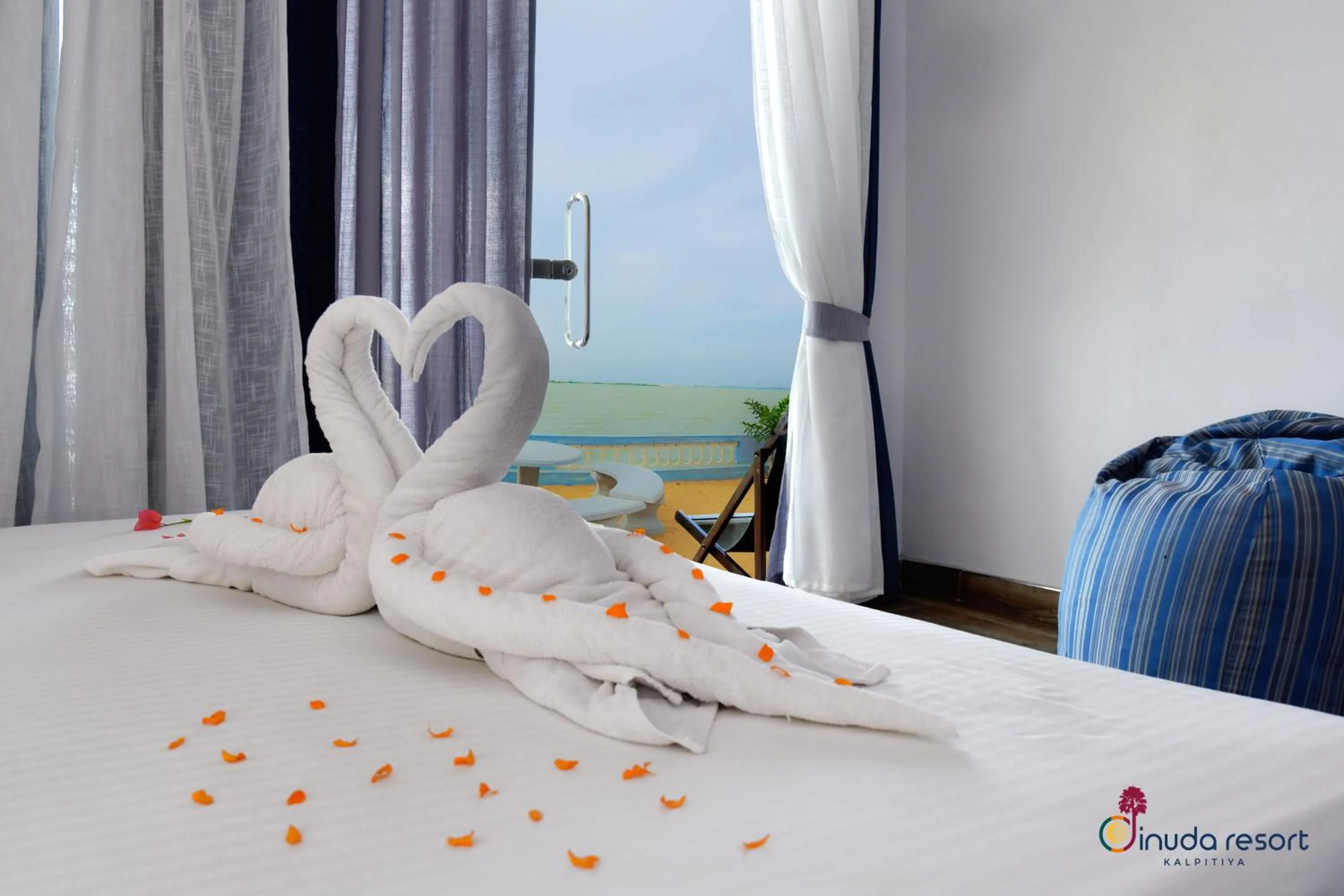 Bed in Dinuda Lagoon Hotel