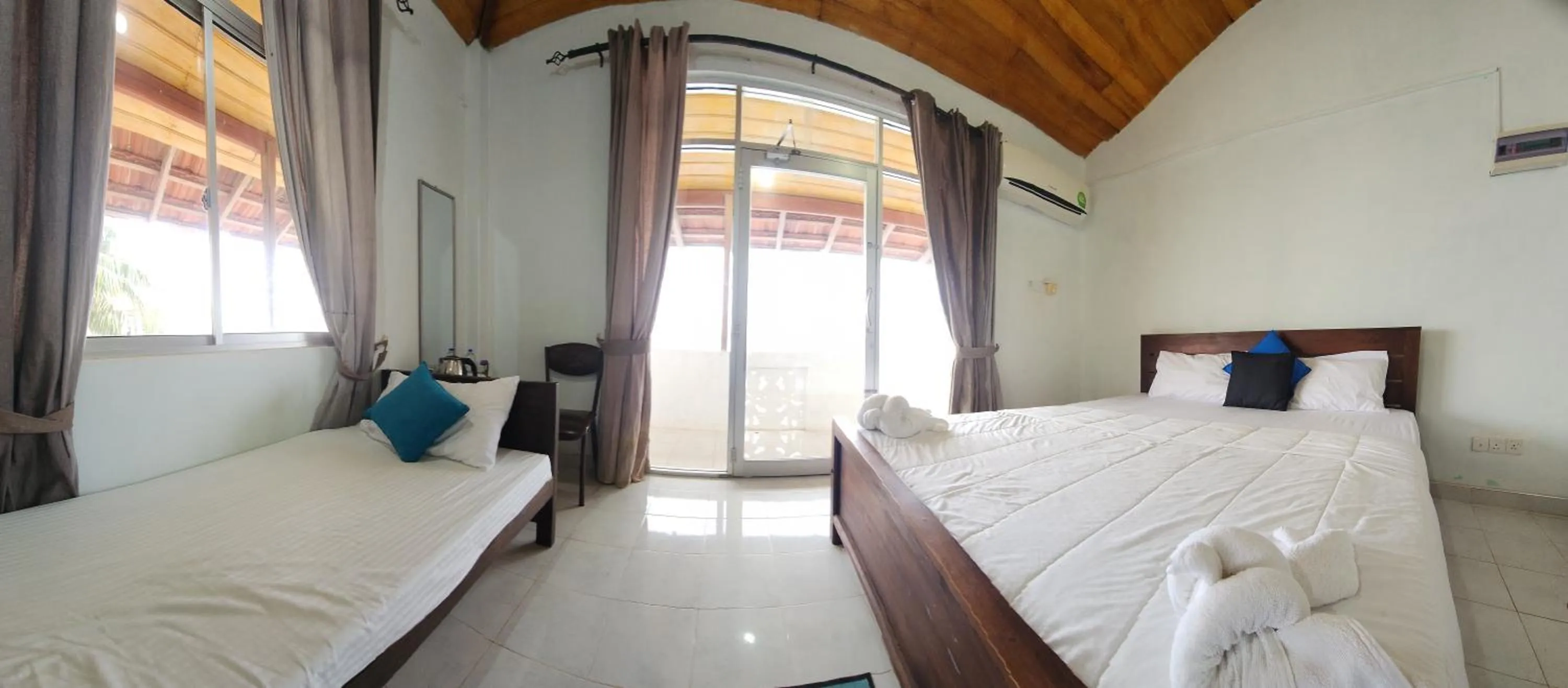 Bed in Dinuda Lagoon Hotel