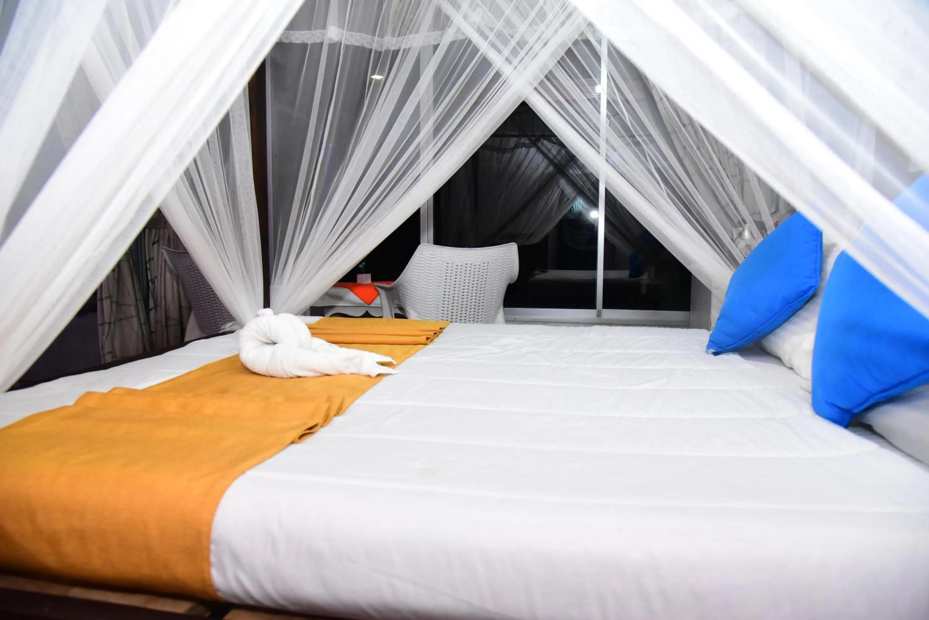 Bed in Dinuda Lagoon Hotel