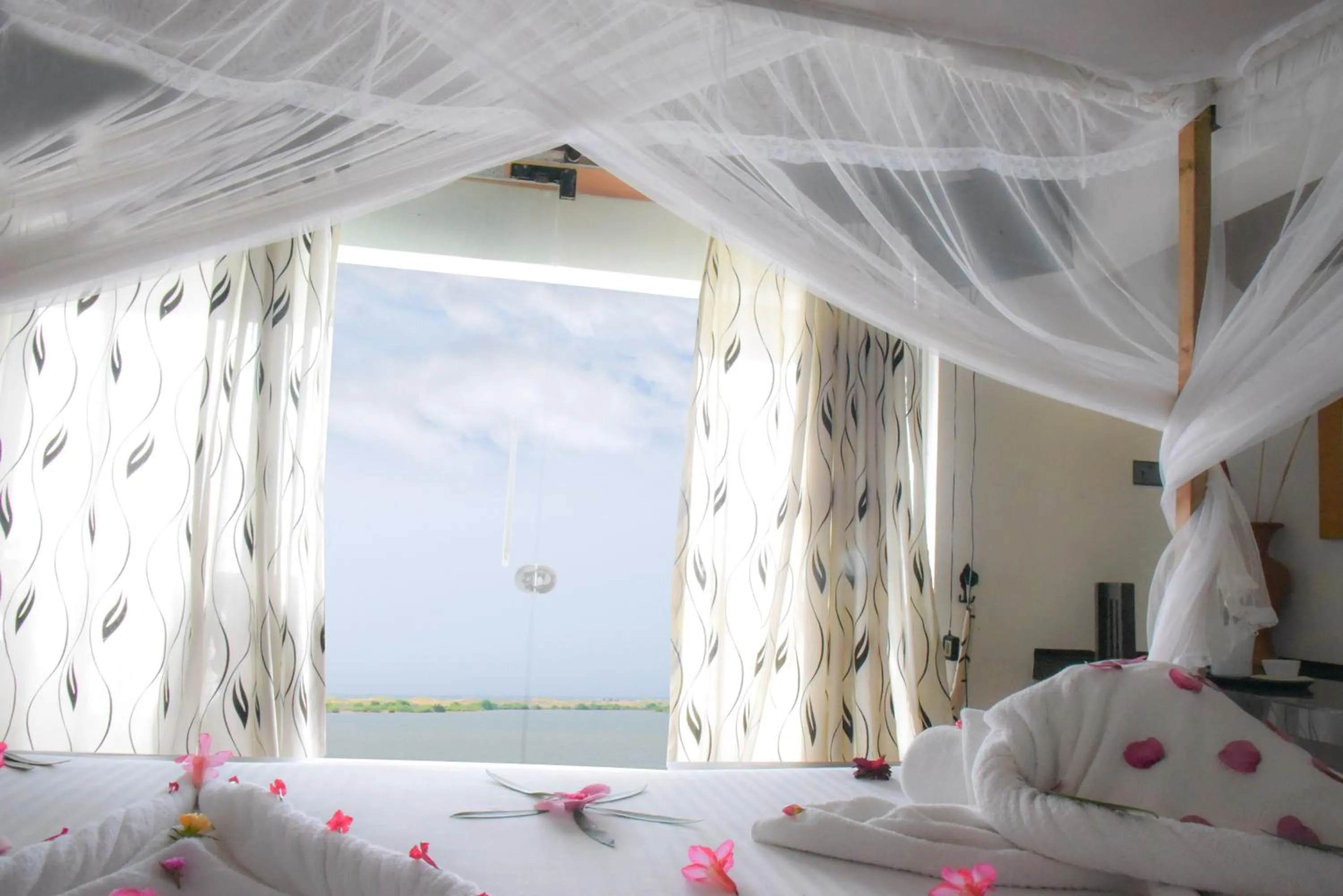Bed in Dinuda Lagoon Hotel