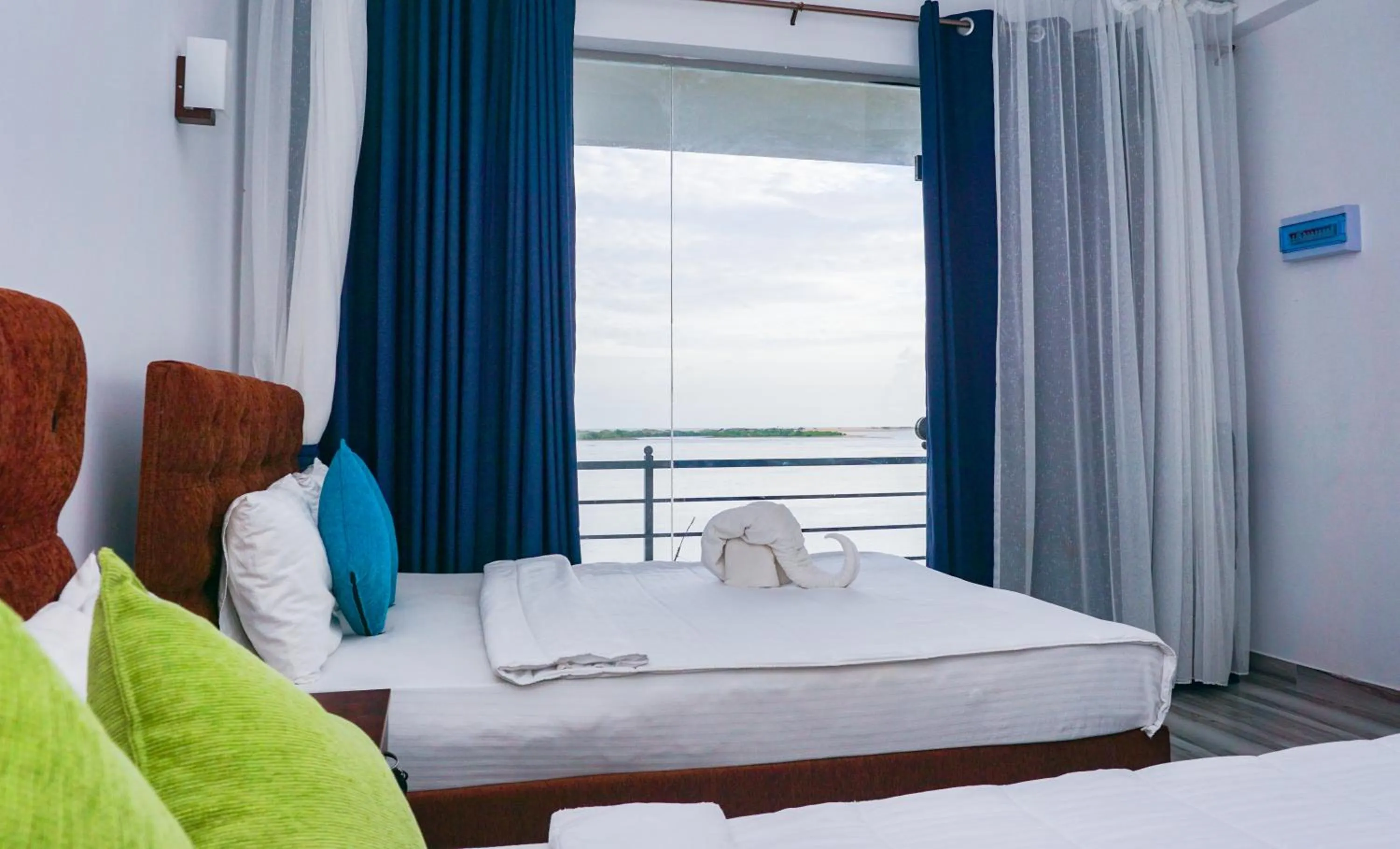 Bed in Dinuda Lagoon Hotel