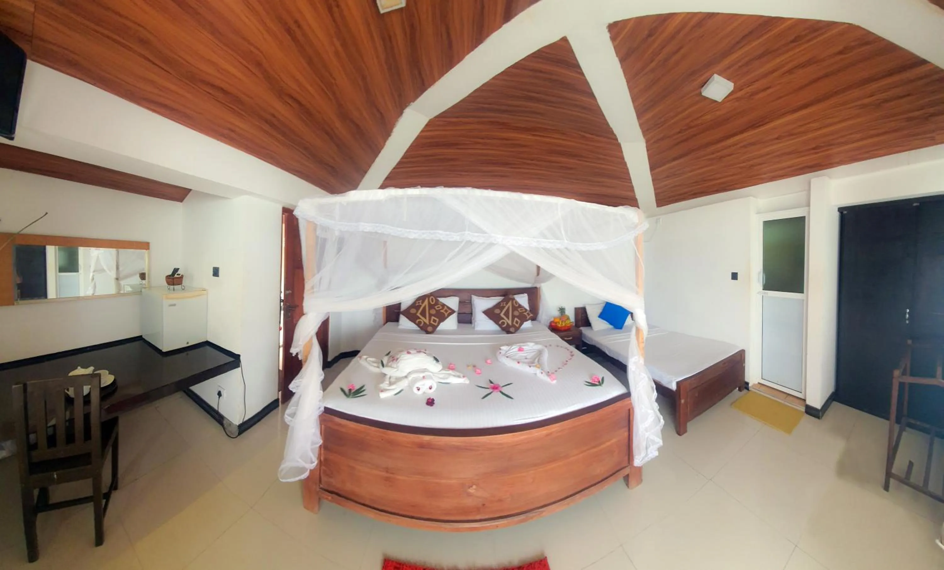 Bed in Dinuda Lagoon Hotel