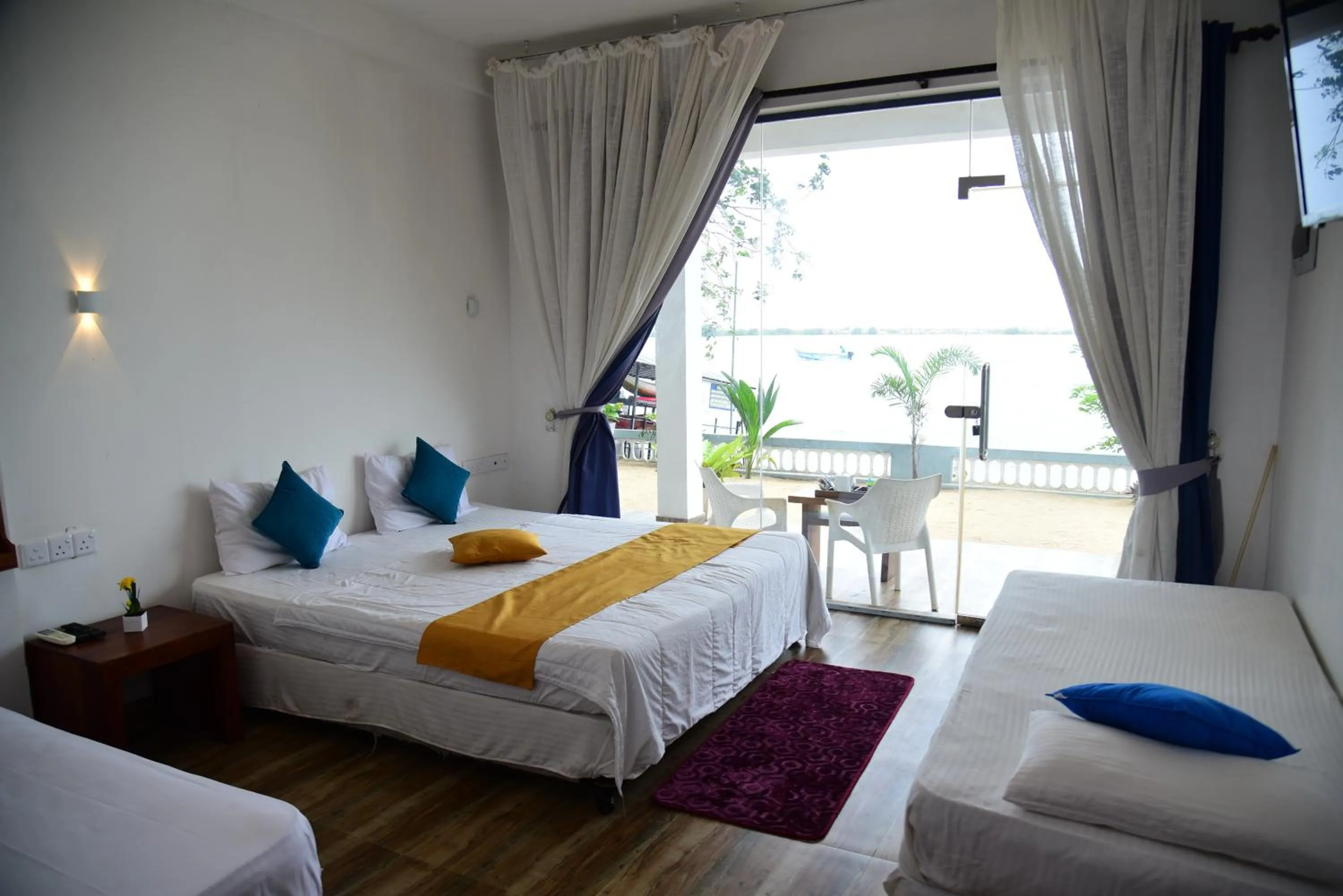 Bed in Dinuda Lagoon Hotel