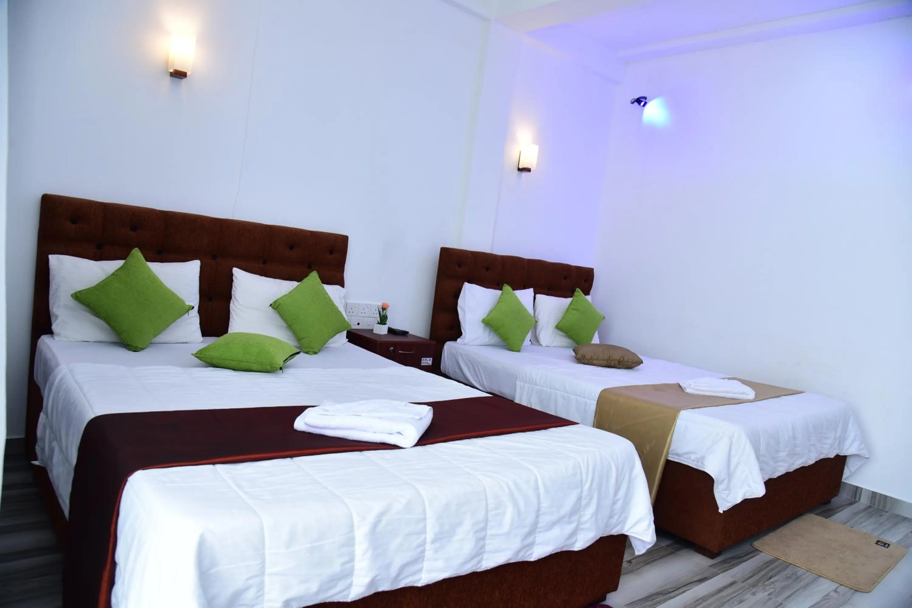 Bed in Dinuda Lagoon Hotel