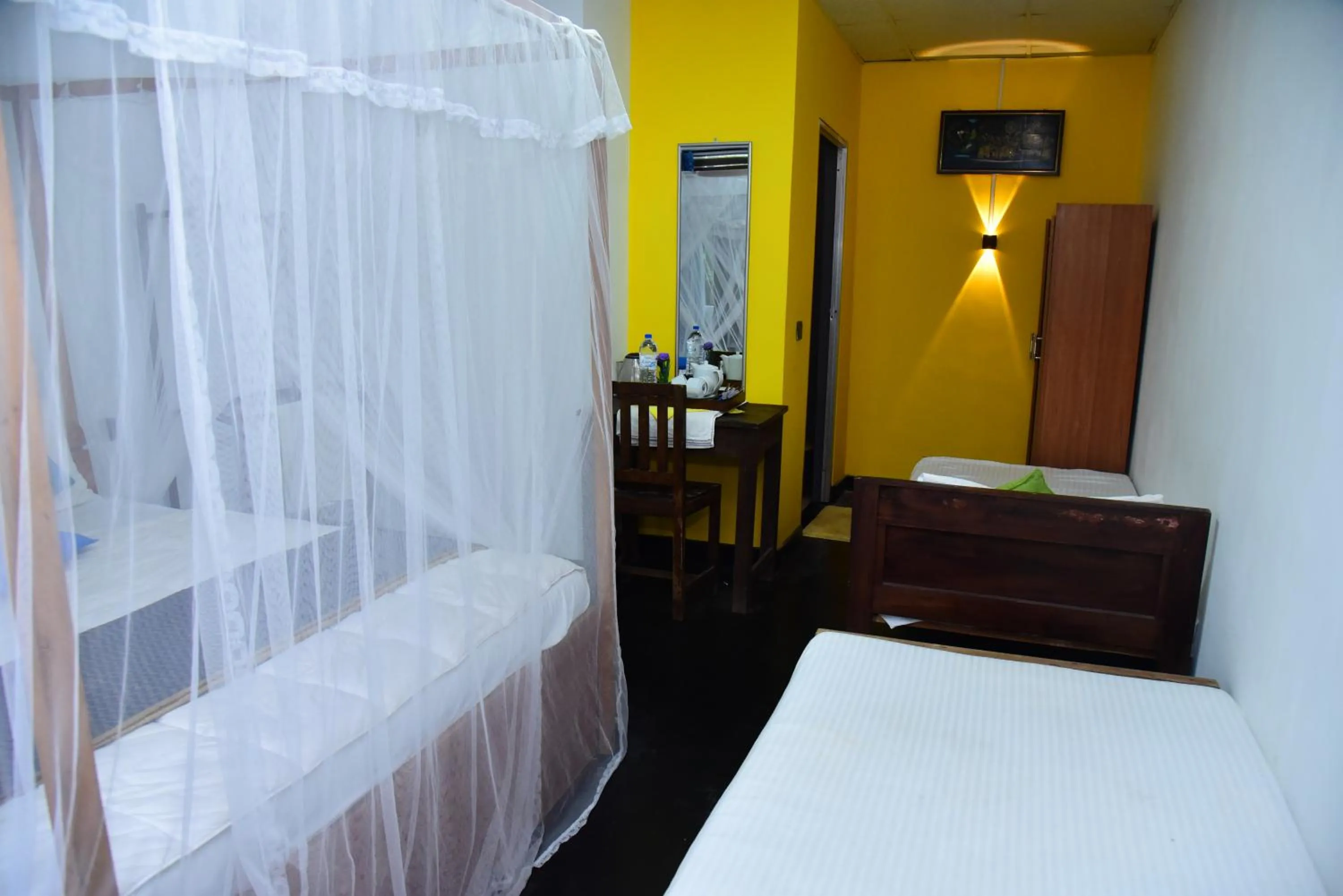 Bed in Dinuda Lagoon Hotel