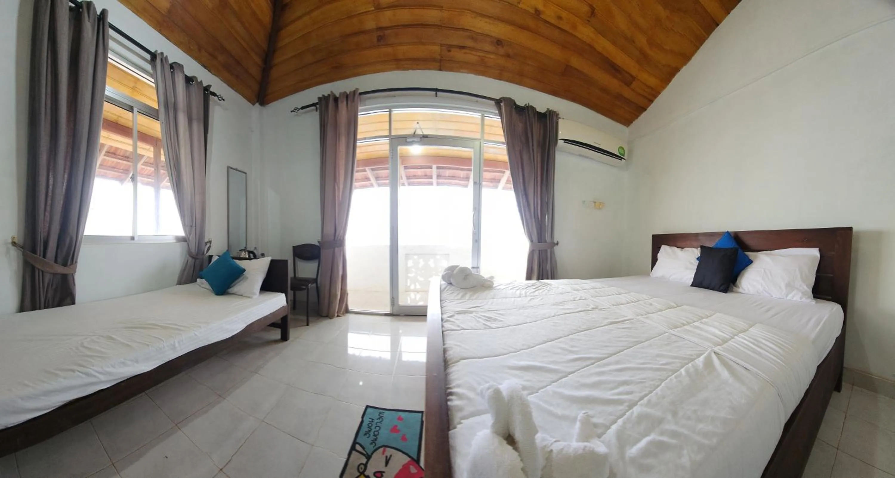 Bed in Dinuda Lagoon Hotel