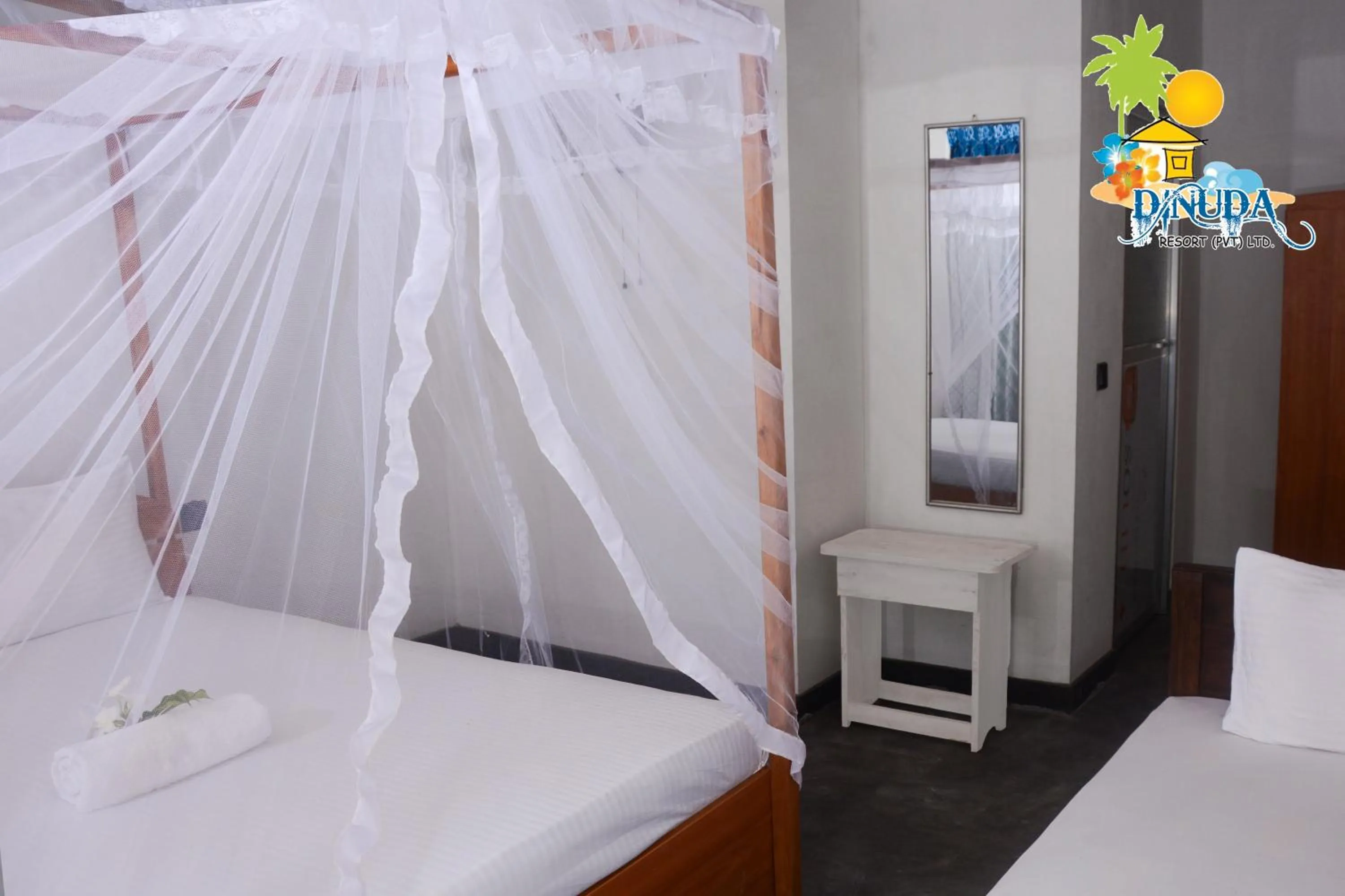 Bed in Dinuda Lagoon Hotel