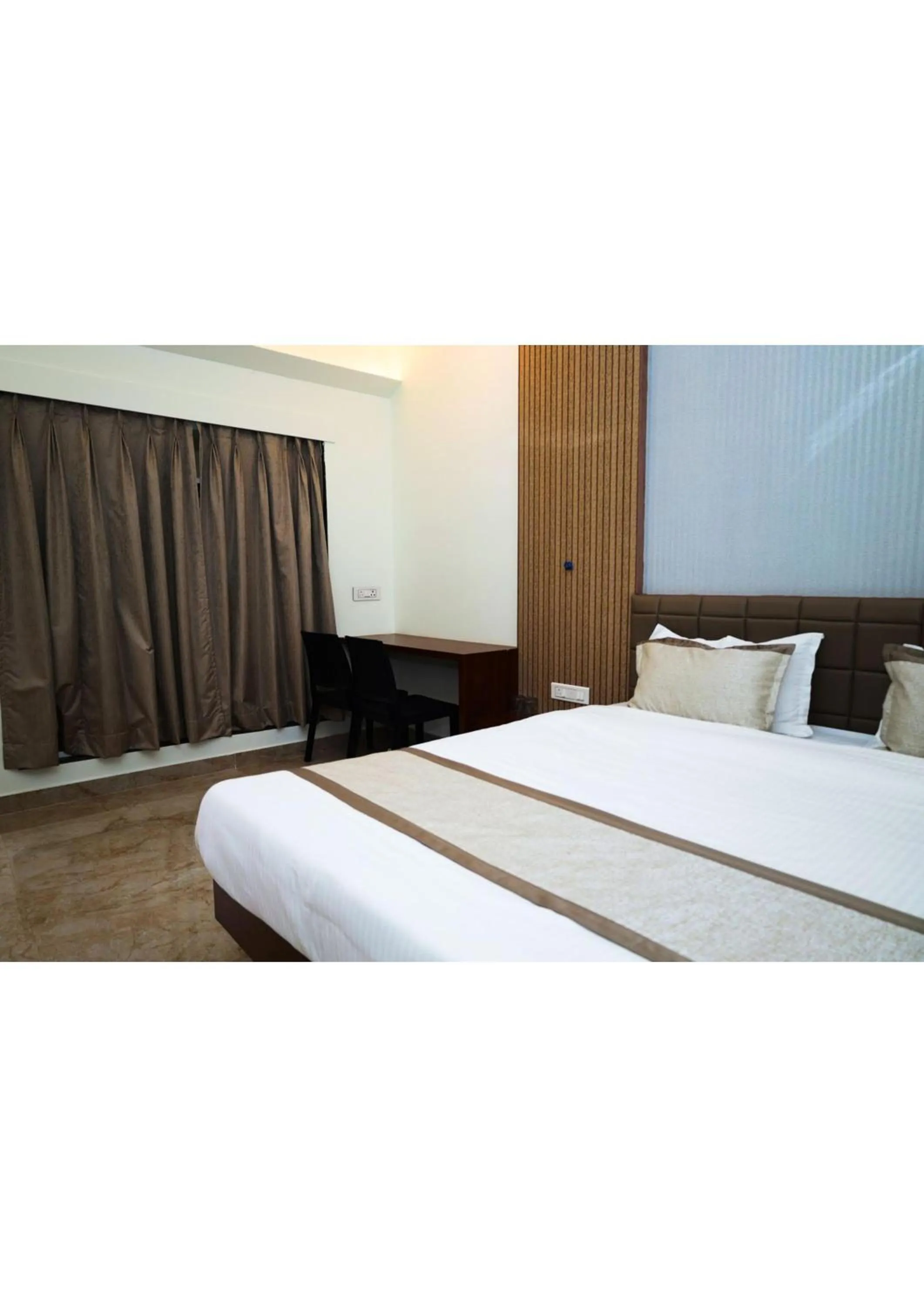 Bed in Nisarg Resort