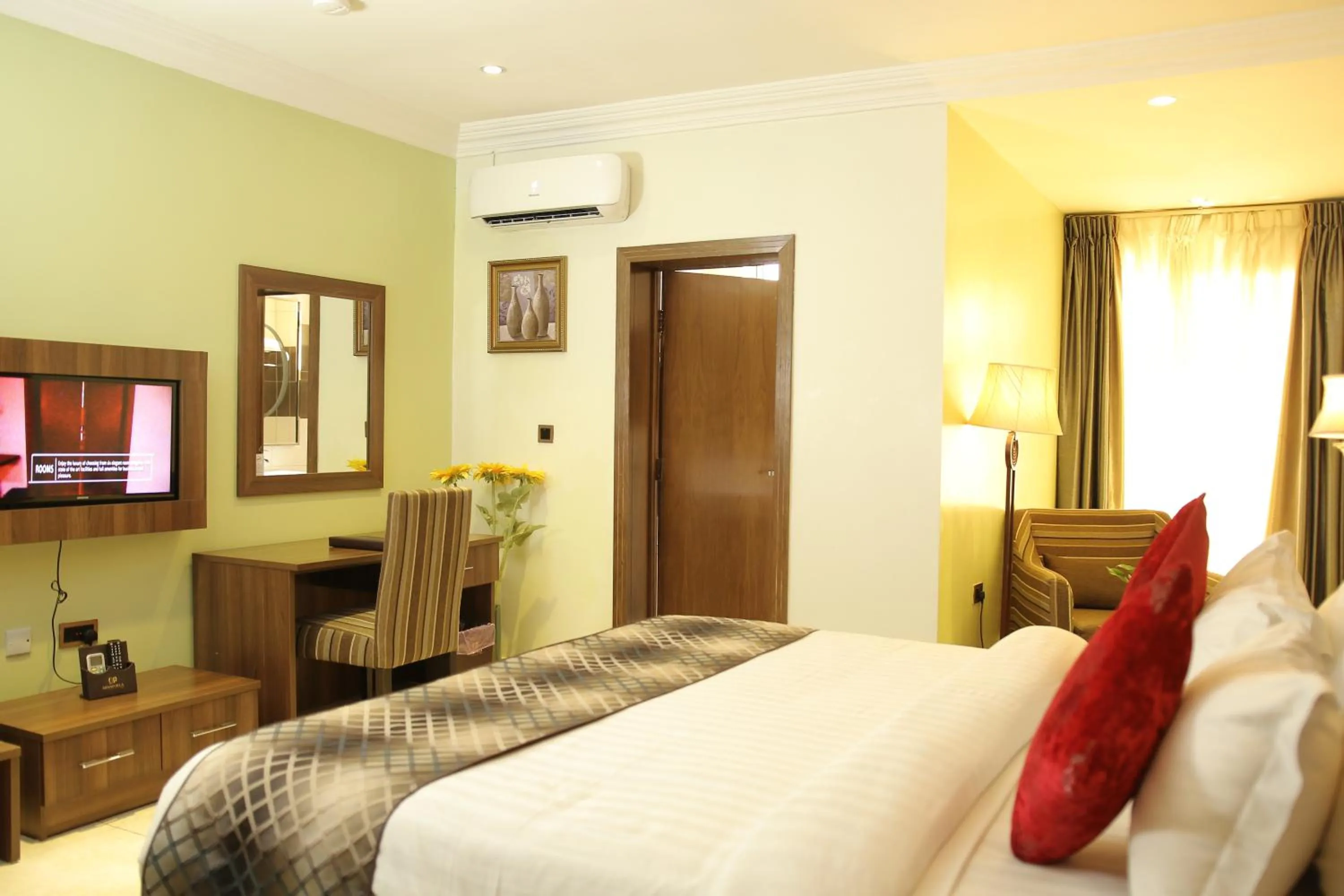 Bed in Grand Pela Hotel & Suites
