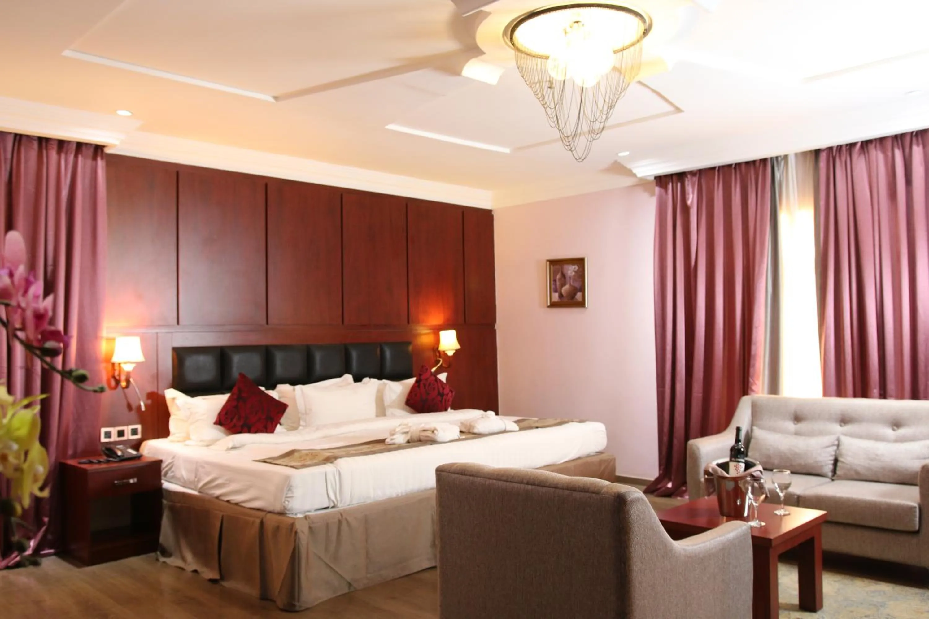 Bed in Grand Pela Hotel & Suites