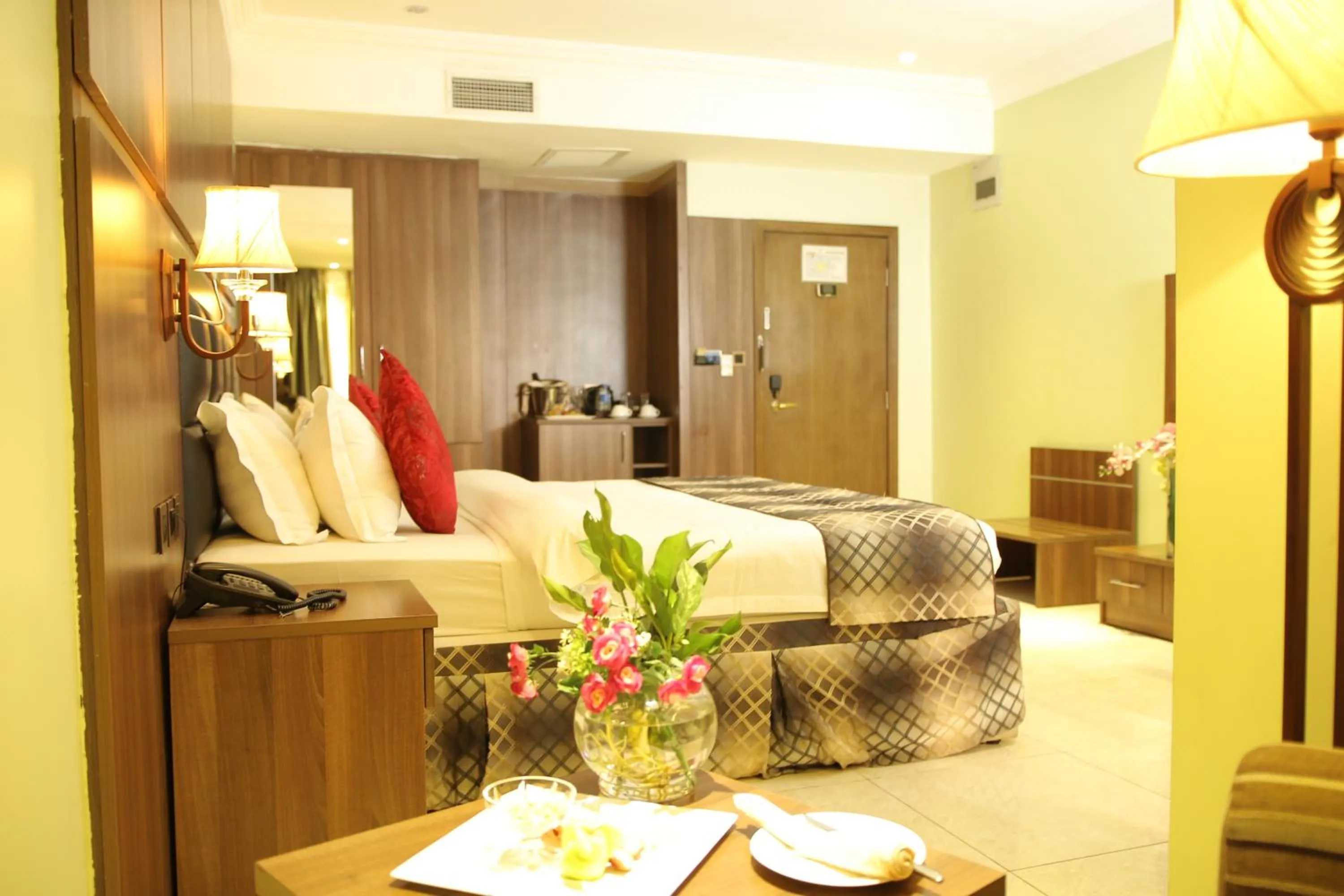 Bed in Grand Pela Hotel & Suites