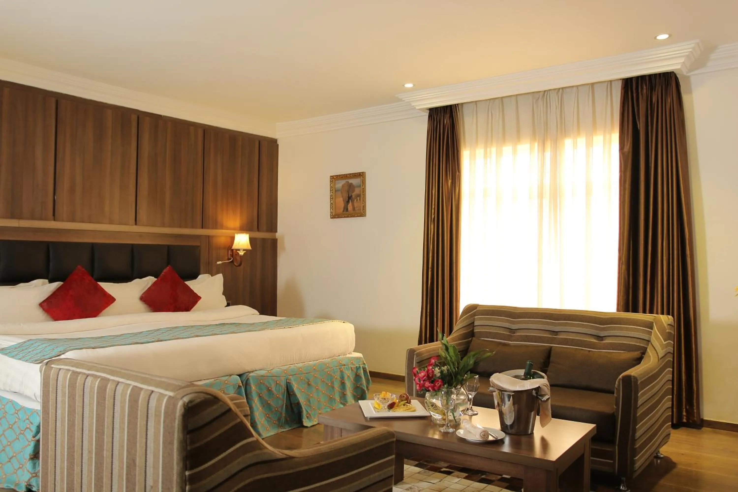 Bed in Grand Pela Hotel & Suites