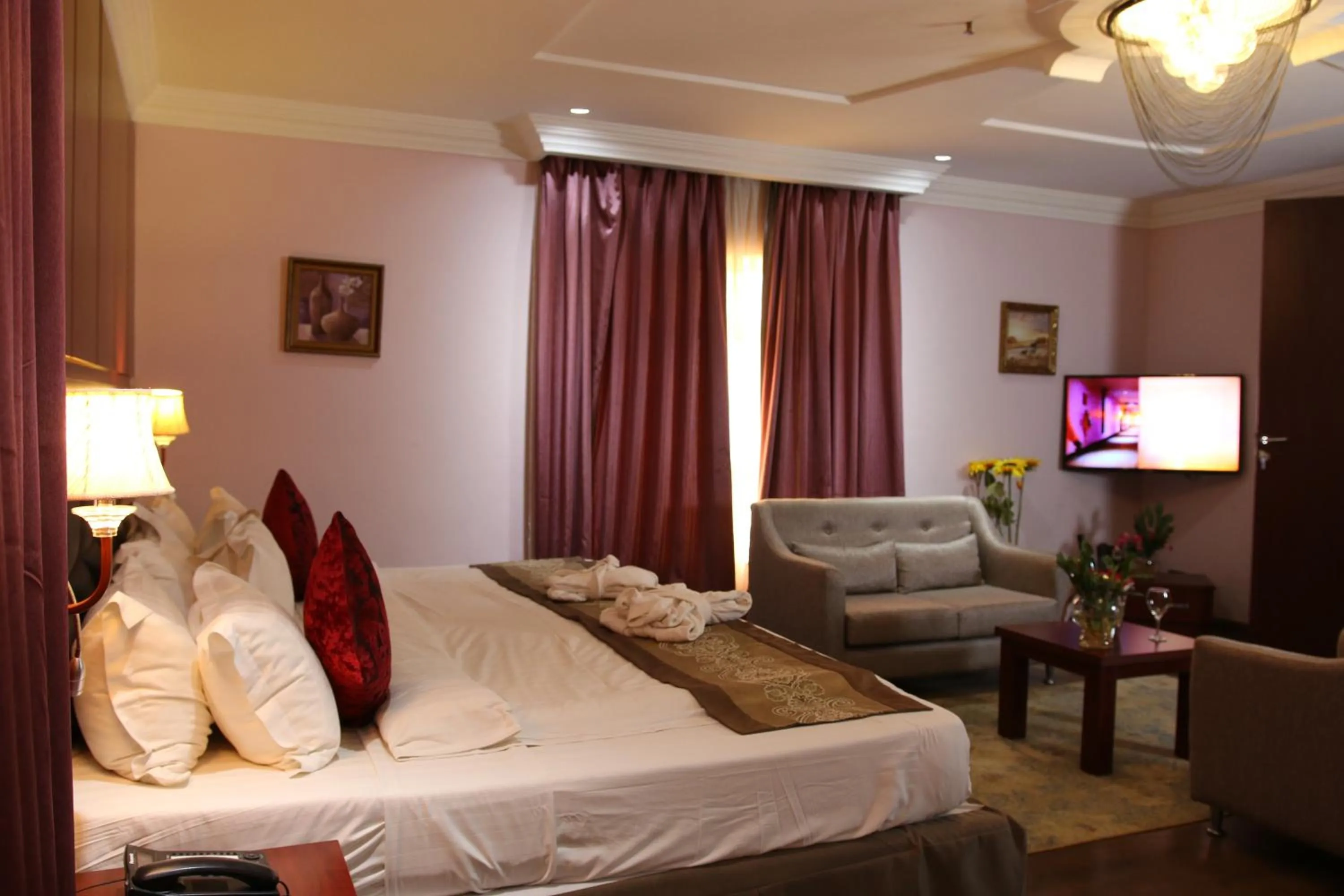 Bed in Grand Pela Hotel & Suites