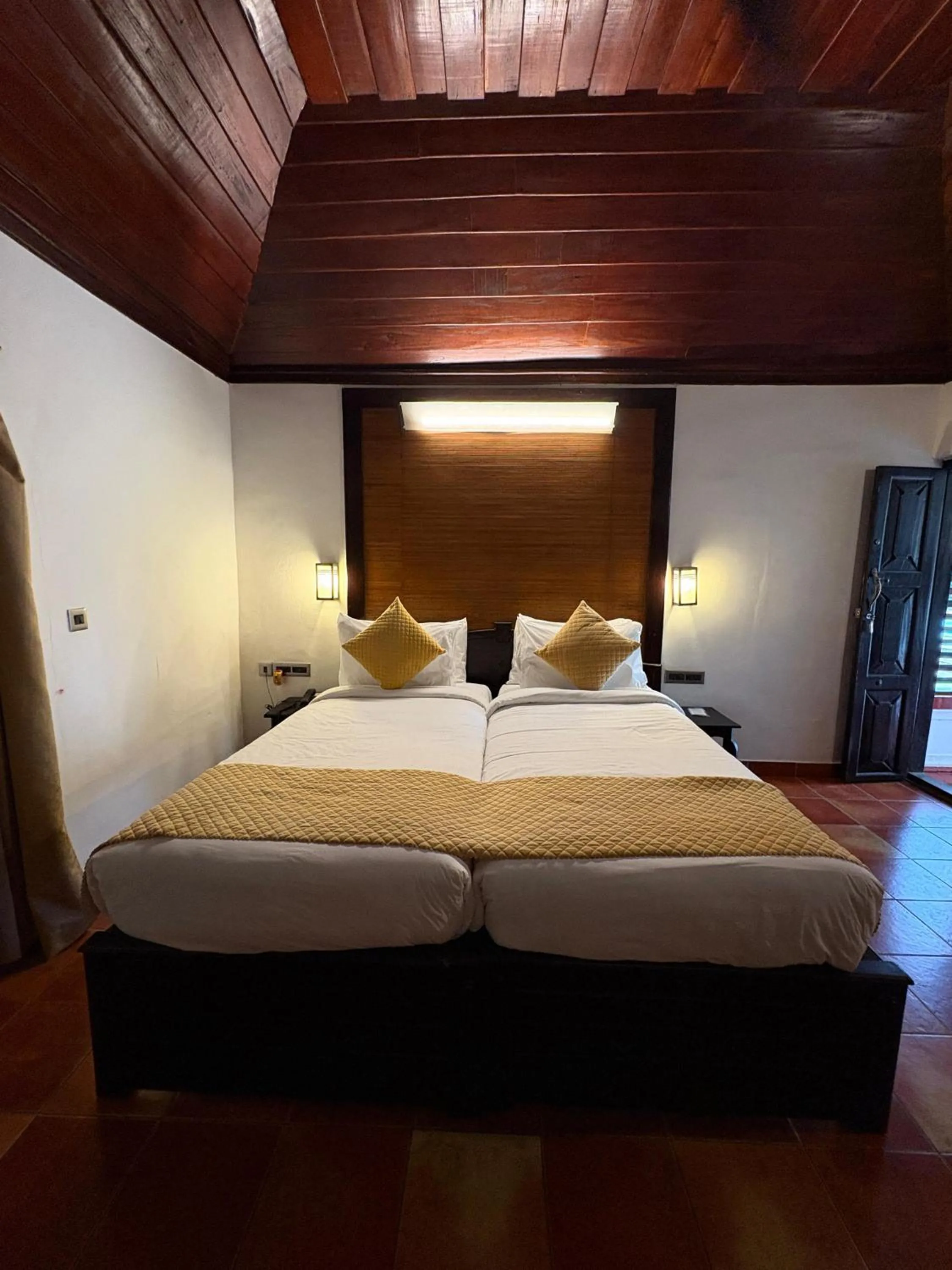 Bedroom, Bed in Kumarakom Tharavadu - A Heritage Hotel, Kumarakom By Perfect Stays