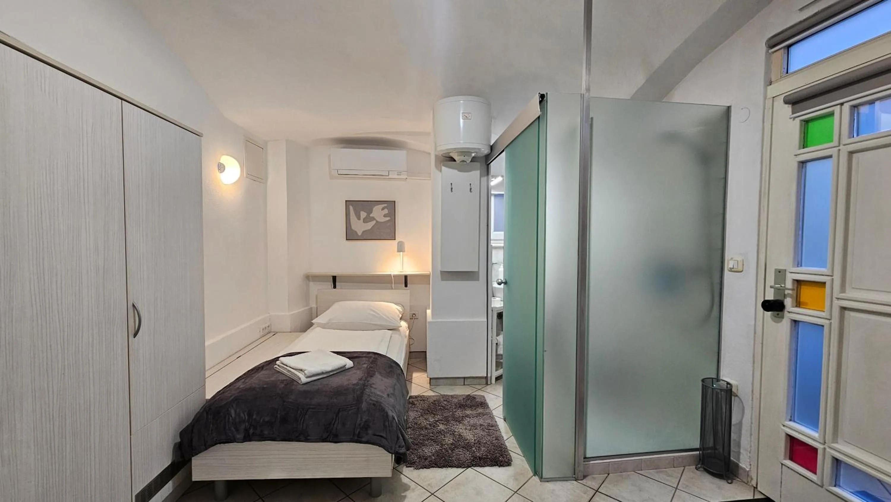 Shower, Bed in Tiny central studio apartment Nika Ljubljana