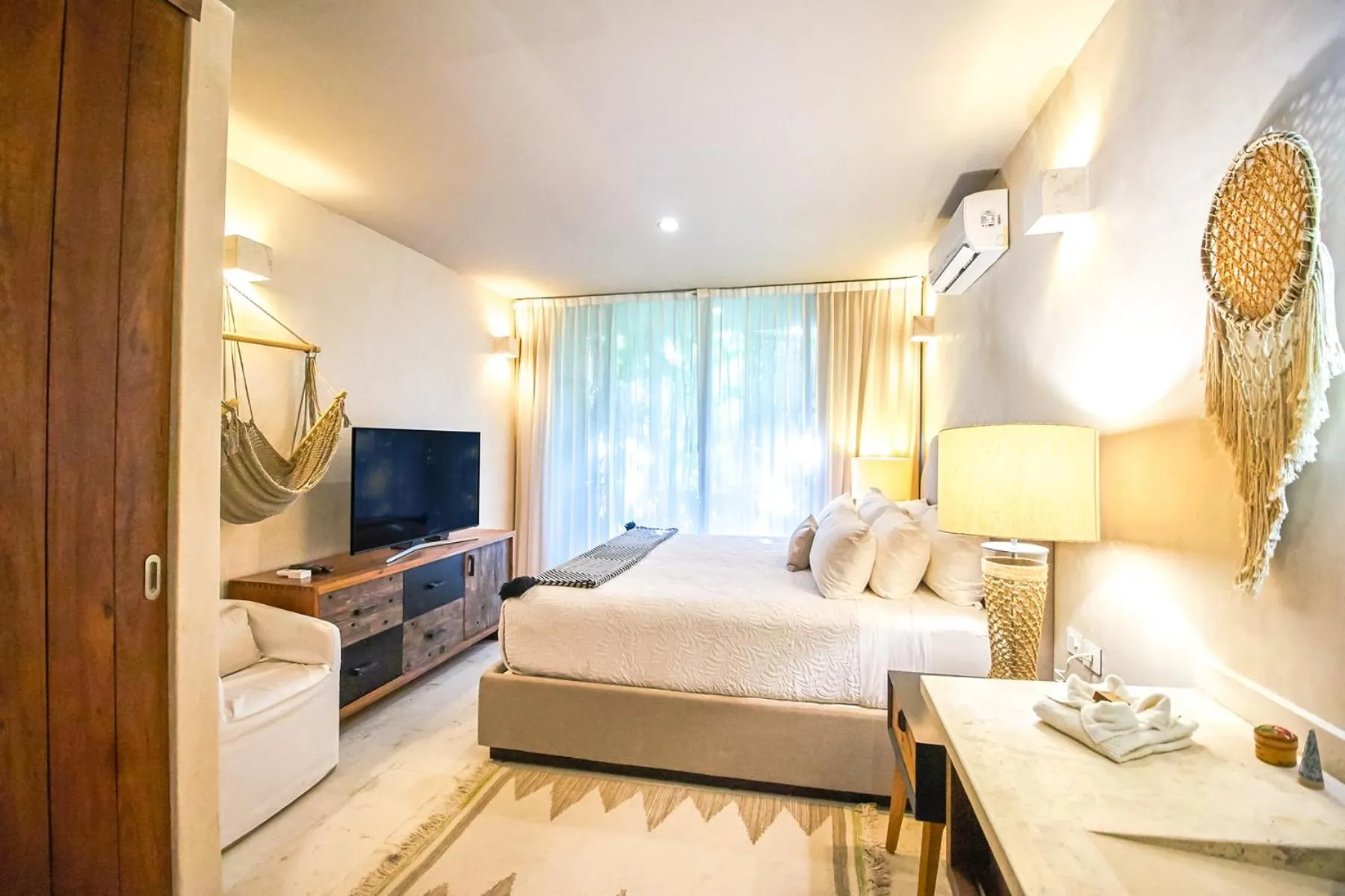 Bedroom, Bed in Eco-chic Design Condos Wrapped in Nature's Elements by Stella Rentals