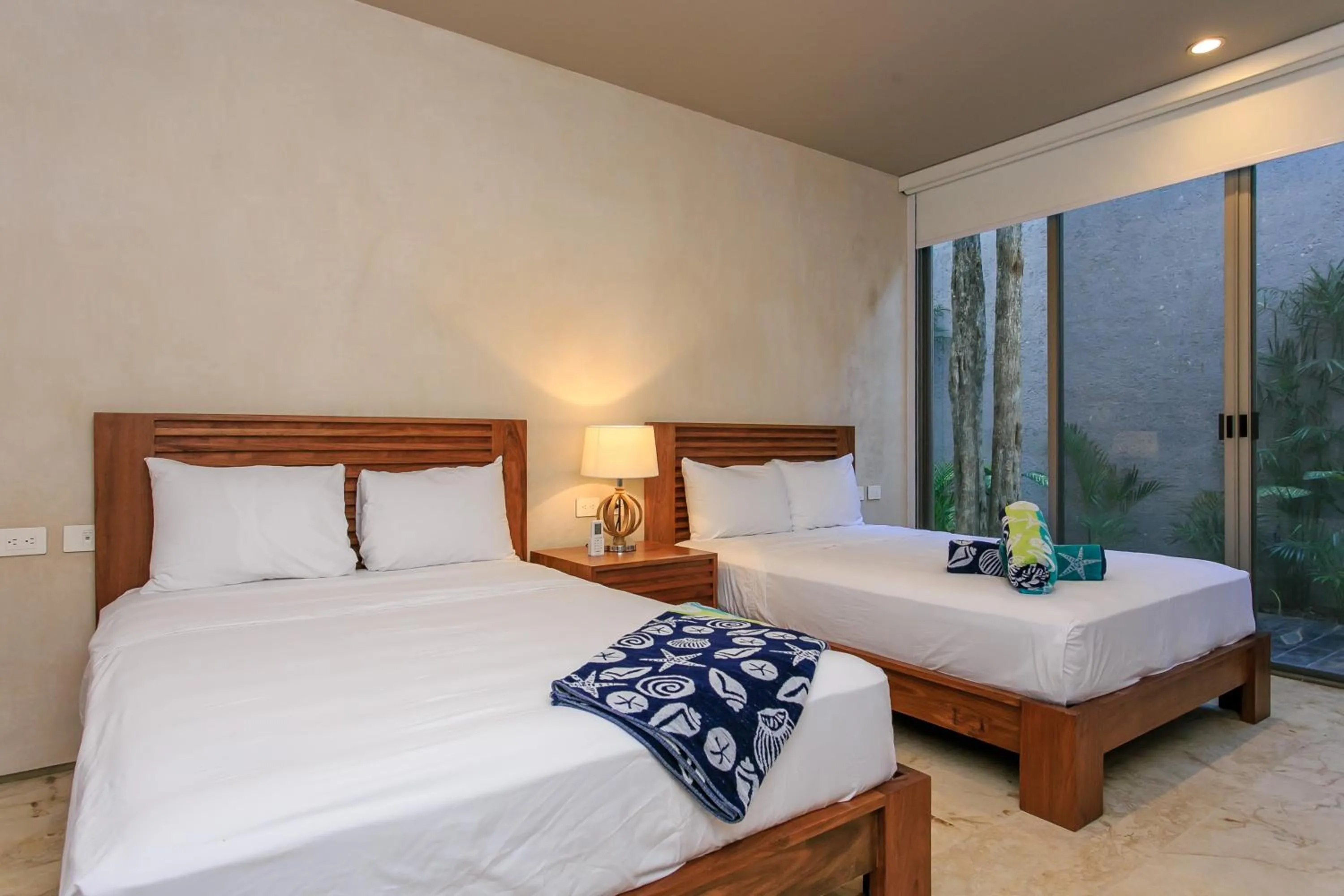 Bedroom, Bed in Eco-chic Design Condos Wrapped in Nature's Elements by Stella Rentals