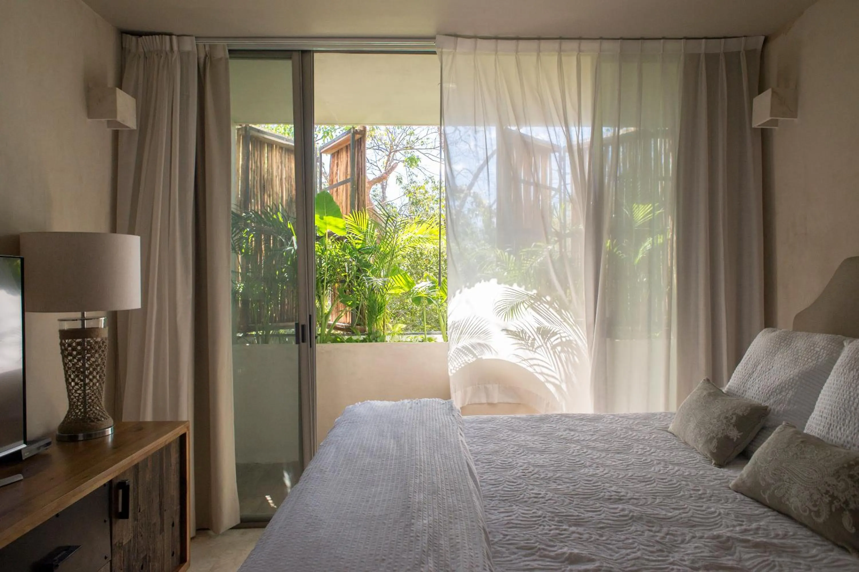 Bedroom, Bed in Eco-chic Design Condos Wrapped in Nature's Elements by Stella Rentals