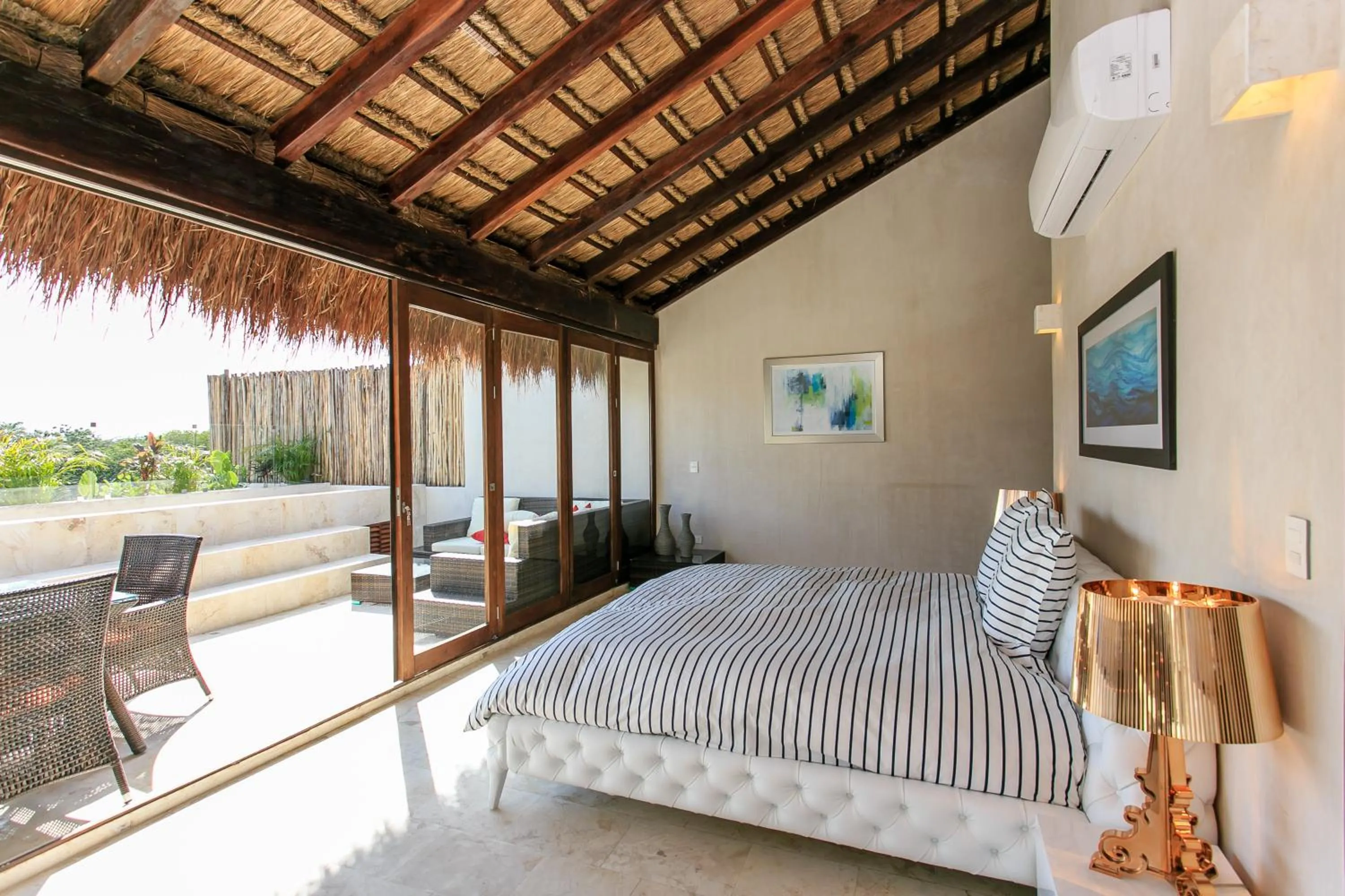 Balcony/Terrace, Bed in Eco-chic Design Condos Wrapped in Nature's Elements by Stella Rentals