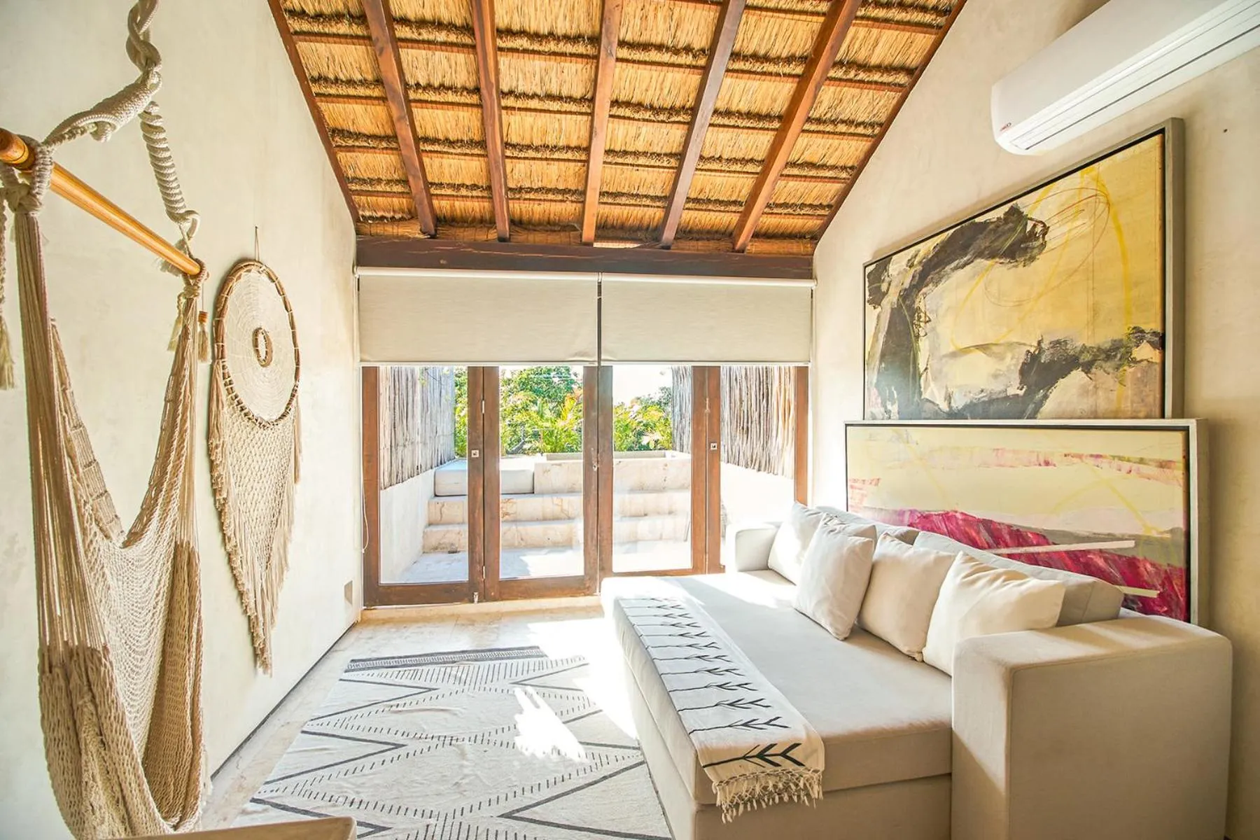 Living room, Bed in Eco-chic Design Condos Wrapped in Nature's Elements by Stella Rentals