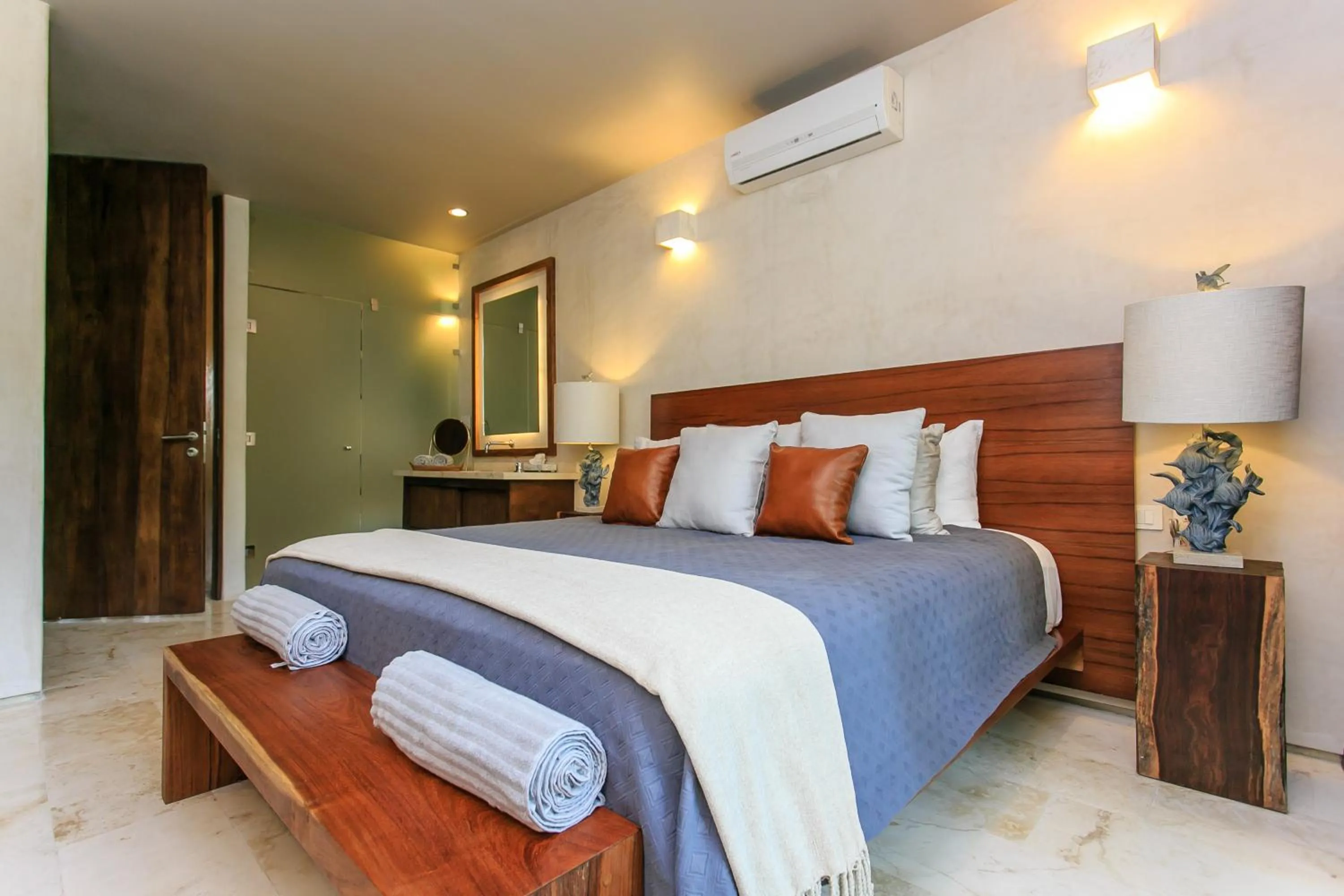 Bedroom, Bed in Eco-chic Design Condos Wrapped in Nature's Elements by Stella Rentals