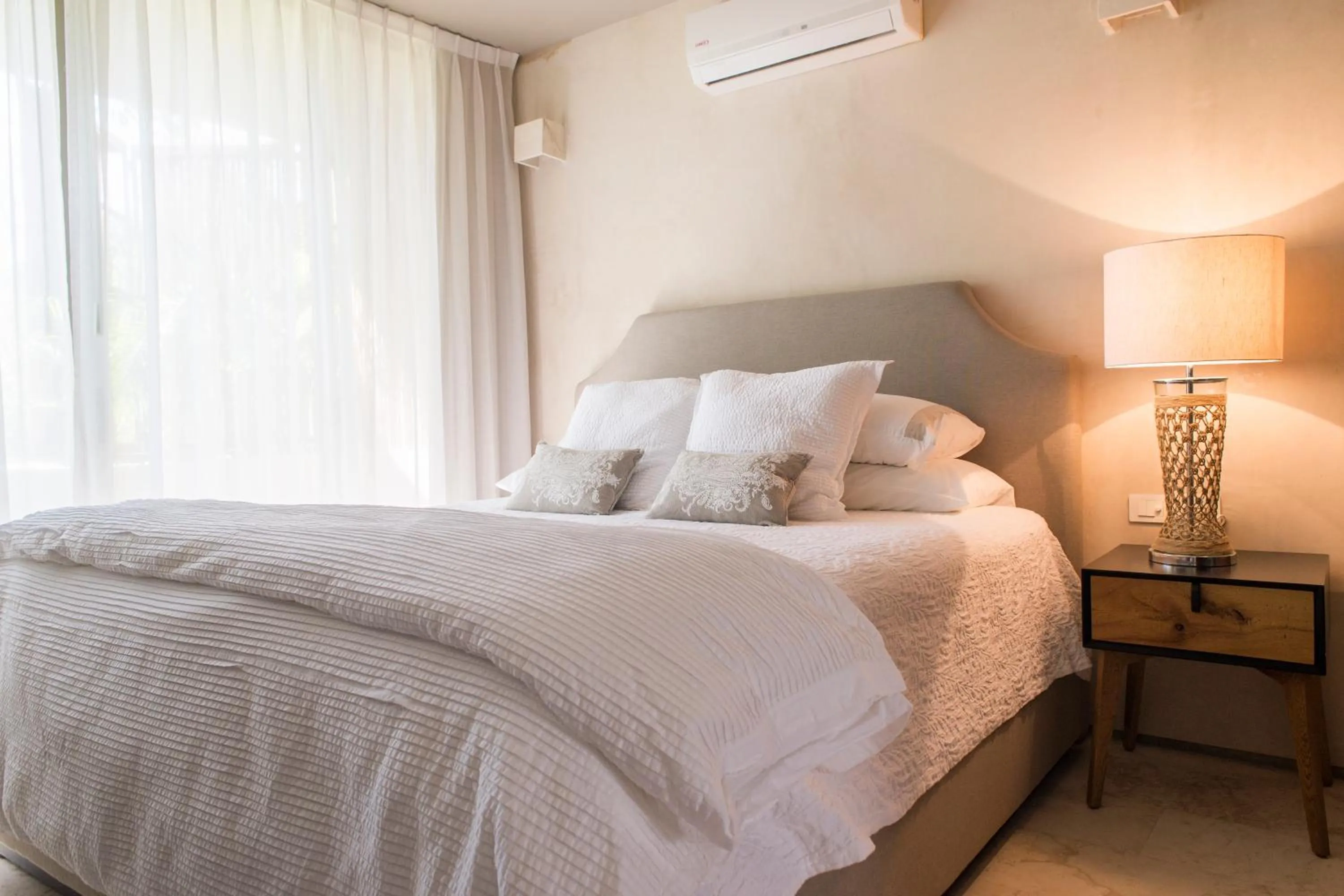 Bedroom, Bed in Eco-chic Design Condos Wrapped in Nature's Elements by Stella Rentals