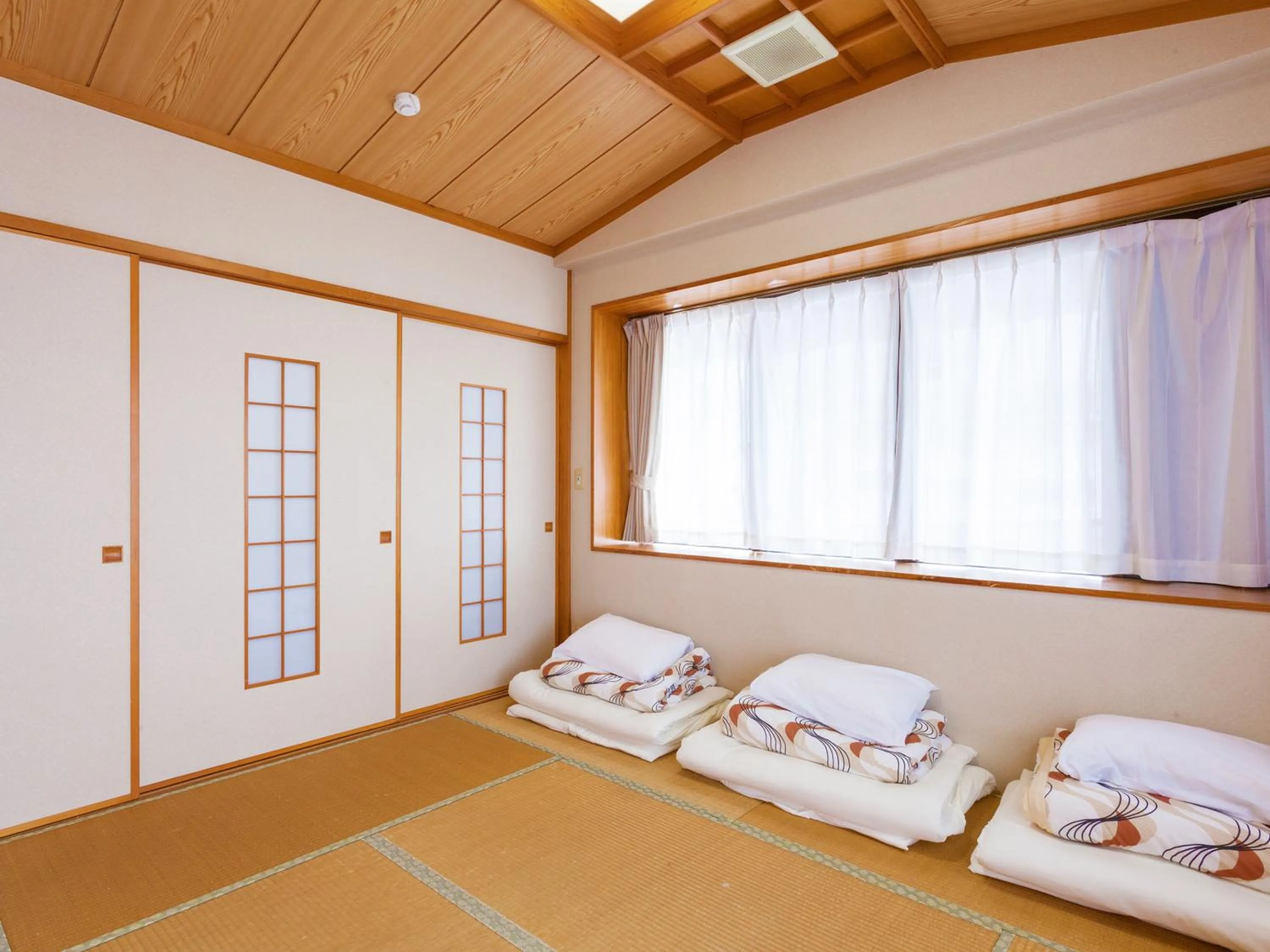 Bedroom, Bed in Kariyushi Condominium Resort Sea Side House