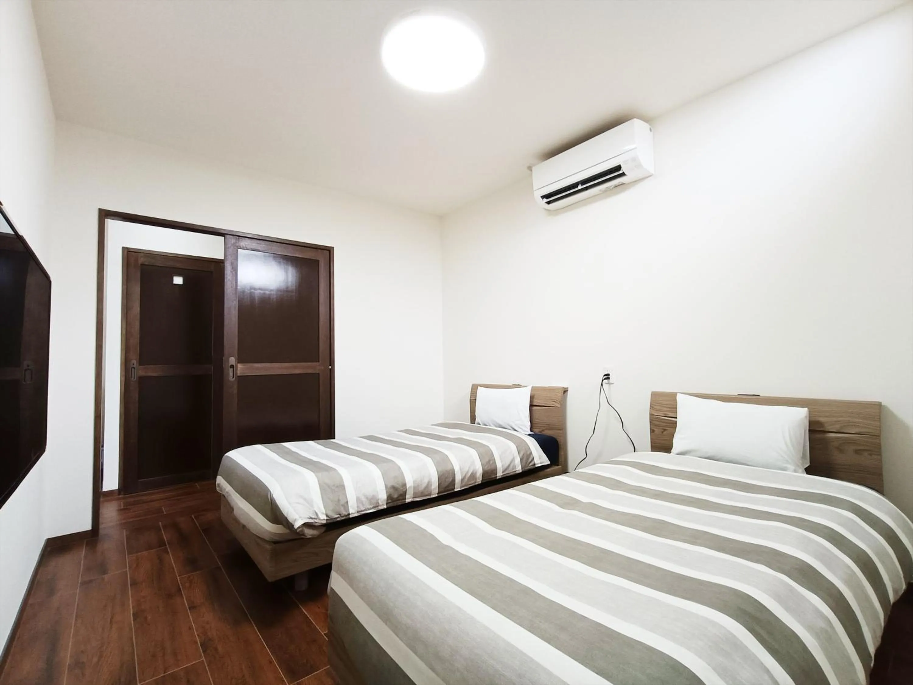 Photo of the whole room, Bed in Kariyushi Condominium Resort Sea Side House