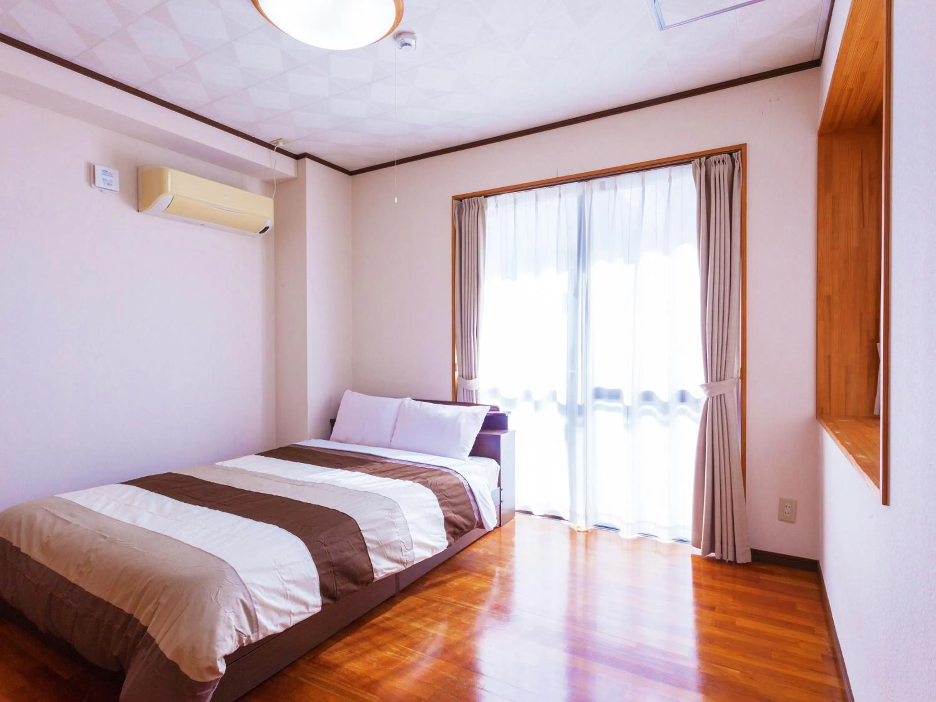 Bedroom, Bed in Kariyushi Condominium Resort Sea Side House